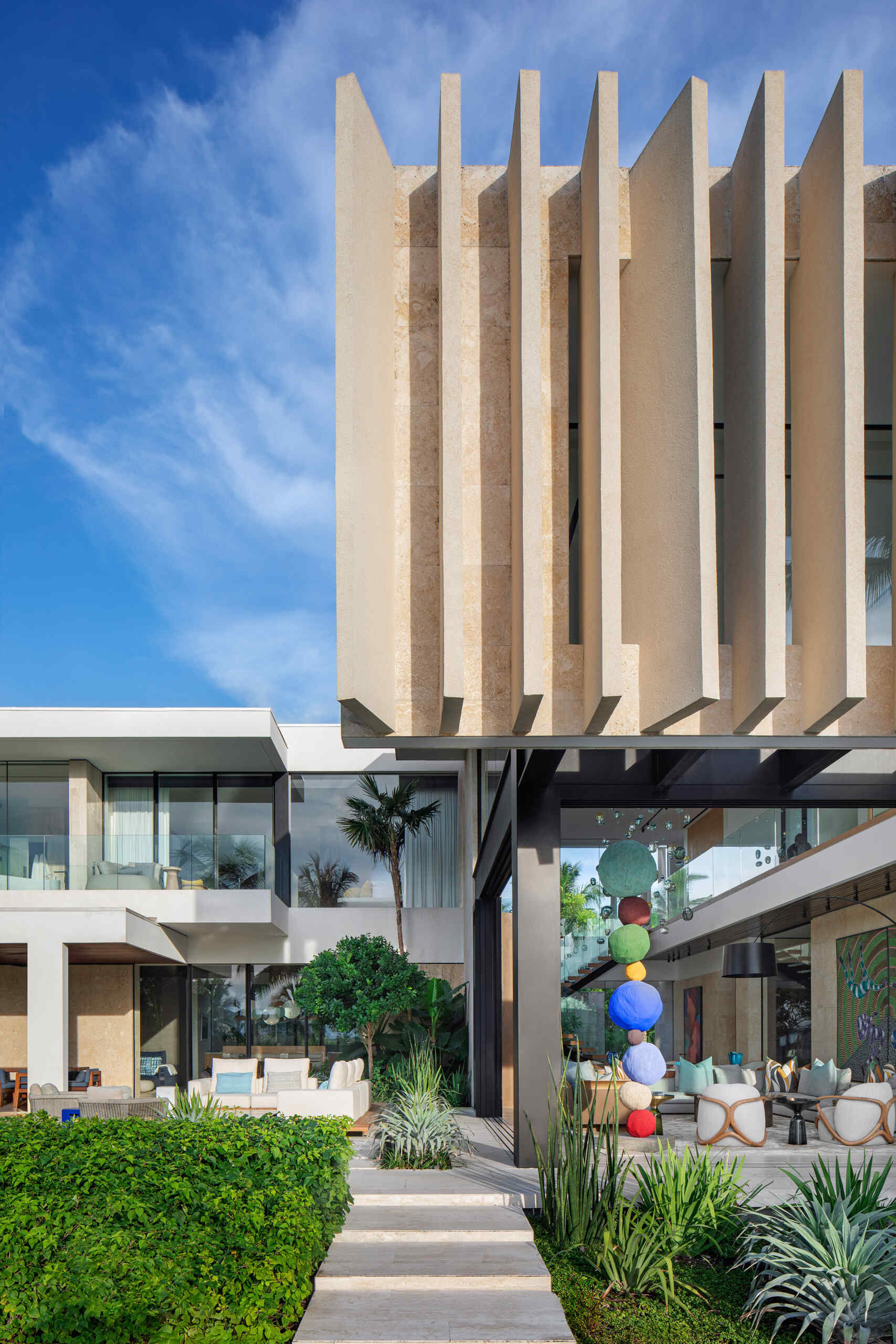 A tropical home with outdoor rooms and an infinity pool that blends naturally with the canal and surrounding greenery.