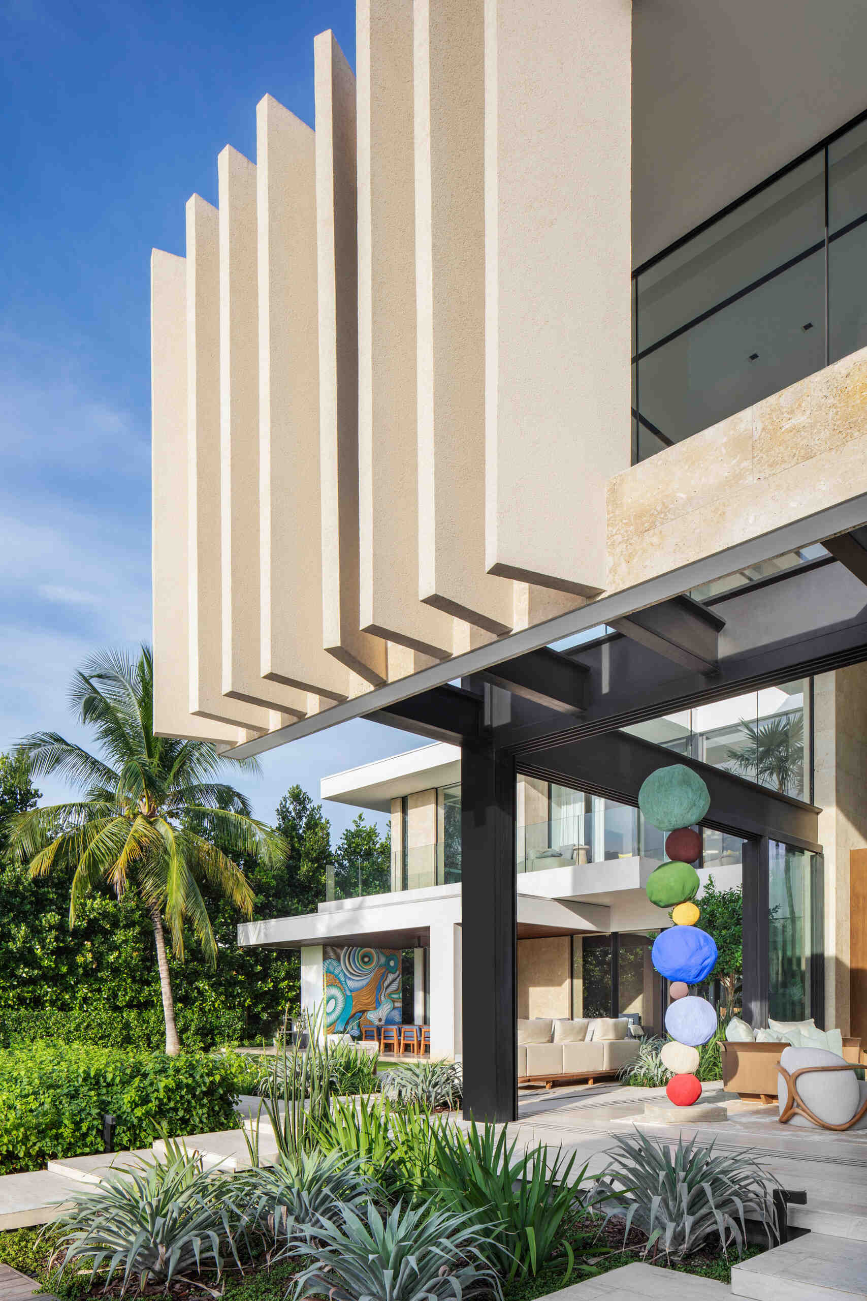 A tropical home with outdoor rooms and an infinity pool that blends naturally with the canal and surrounding greenery.