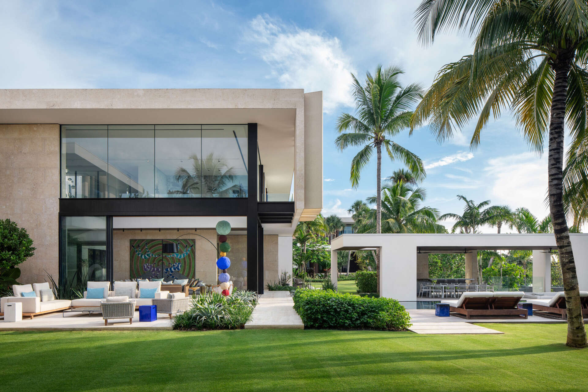 A tropical home with outdoor rooms and an infinity pool that blends naturally with the canal and surrounding greenery.