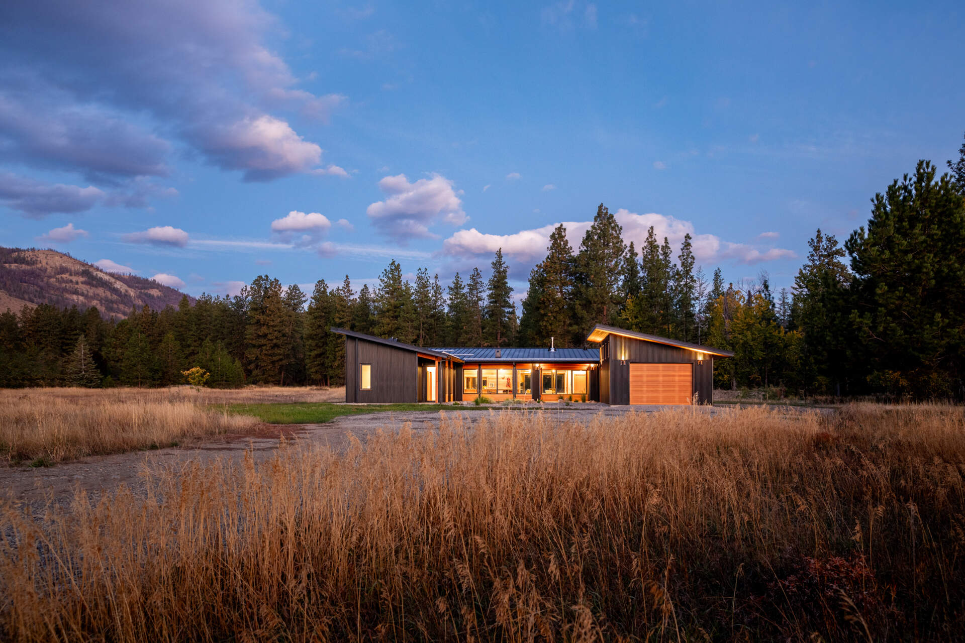 La combinación de cedro, vidrio y metal le da a la casa un aspecto natural en capas que se integra con el paisaje circundante.