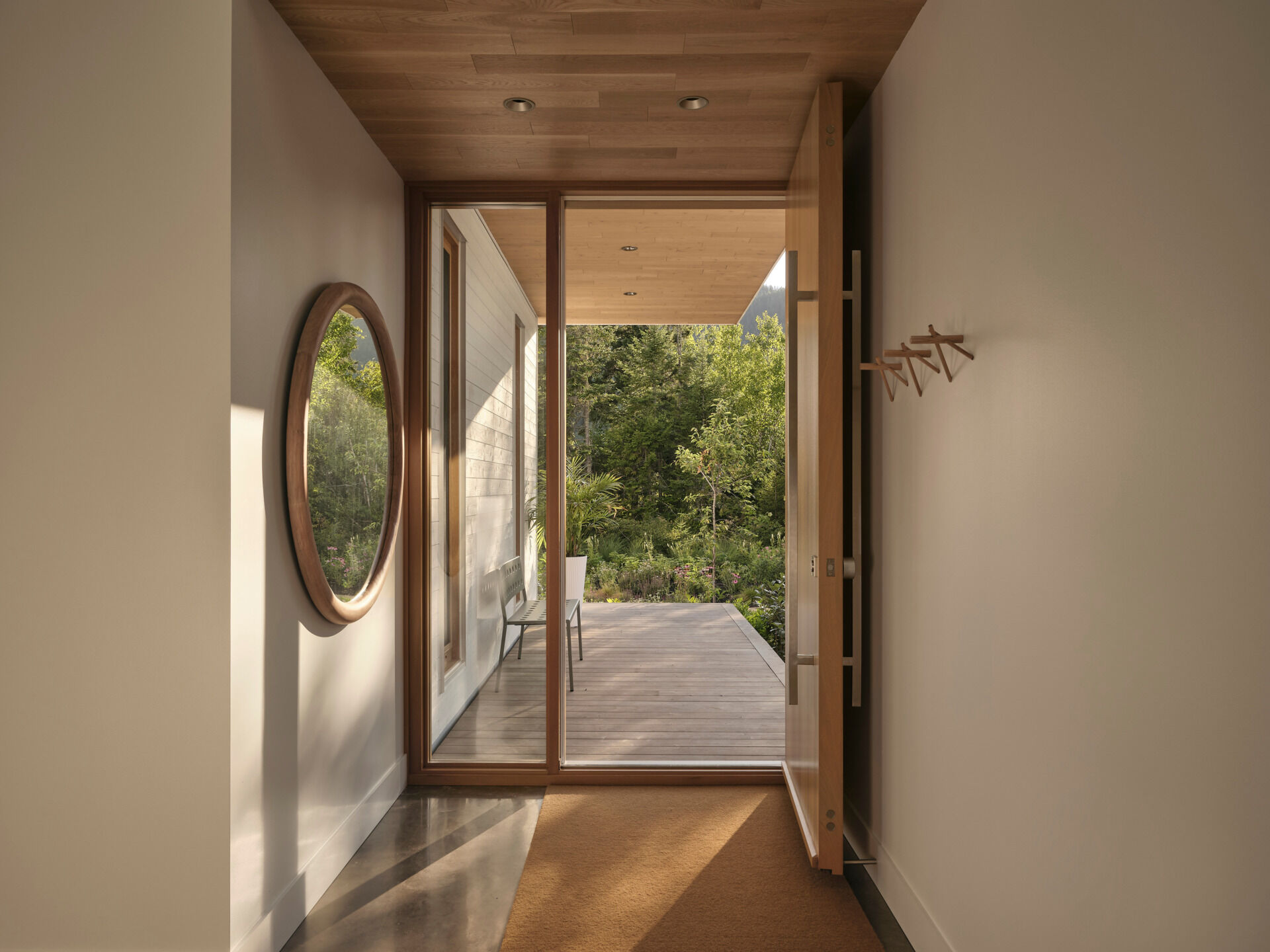 Step inside a warm, light-filled entryway where wood, texture, and stillness welcome you home.