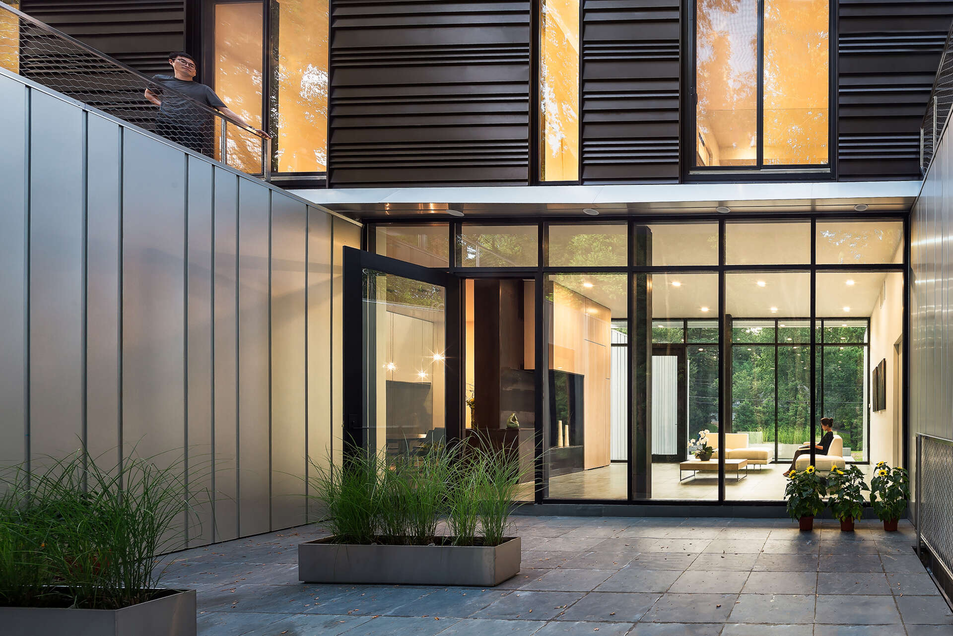 Step inside Bridge House in Virginia, where glass walls and steel details create a welcoming entry that blurs the line between home and forest.