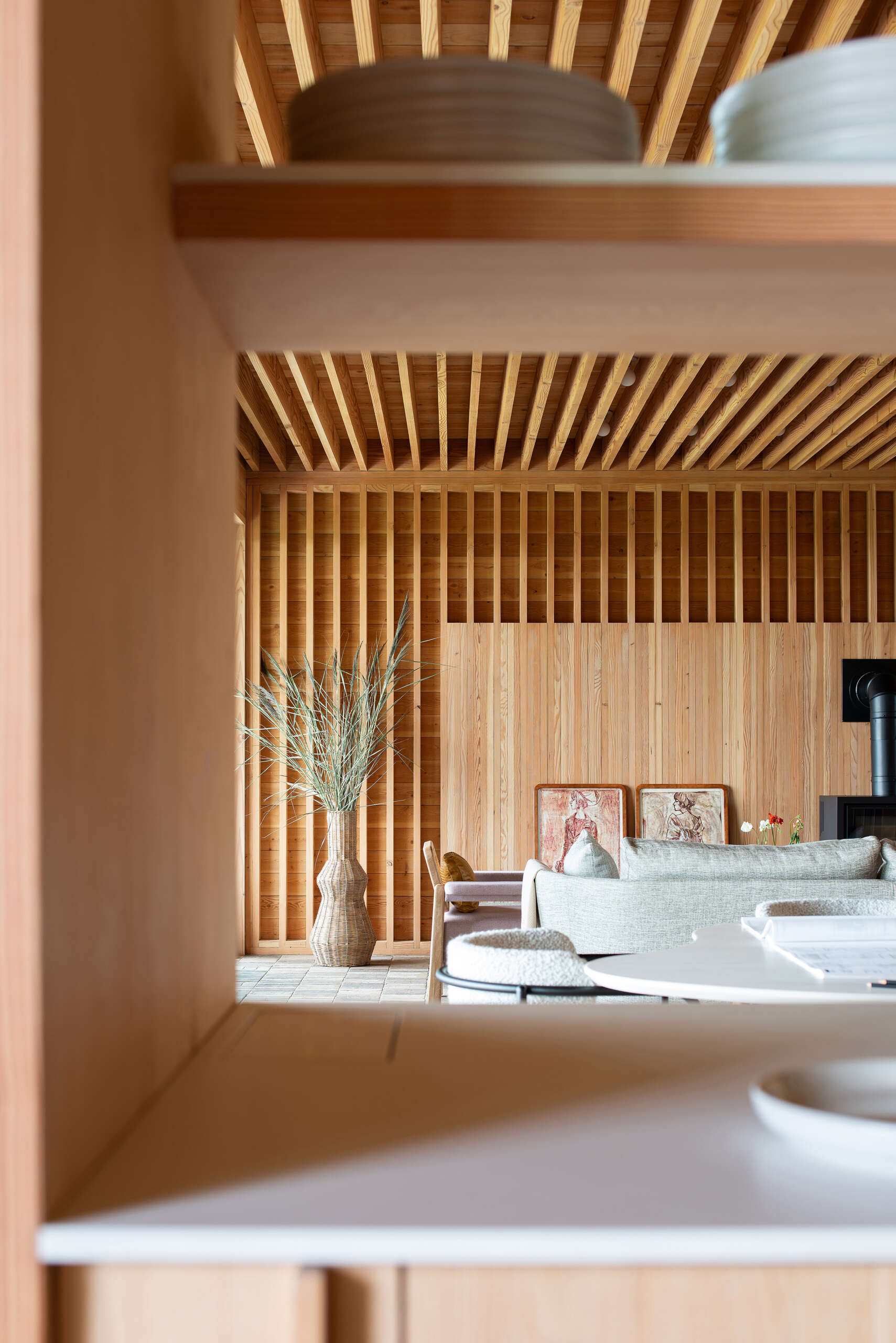 A stripped-back kitchen of open shelving and solid wood surfaces, blending function and natural beauty in perfect balance.