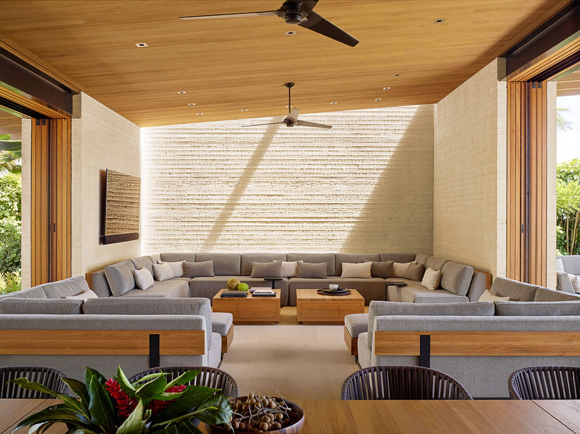 A custom 30-foot U-shaped sofa turns the living room into the heart of this Hawaiian retreat, perfect for lounging or sunset watching.