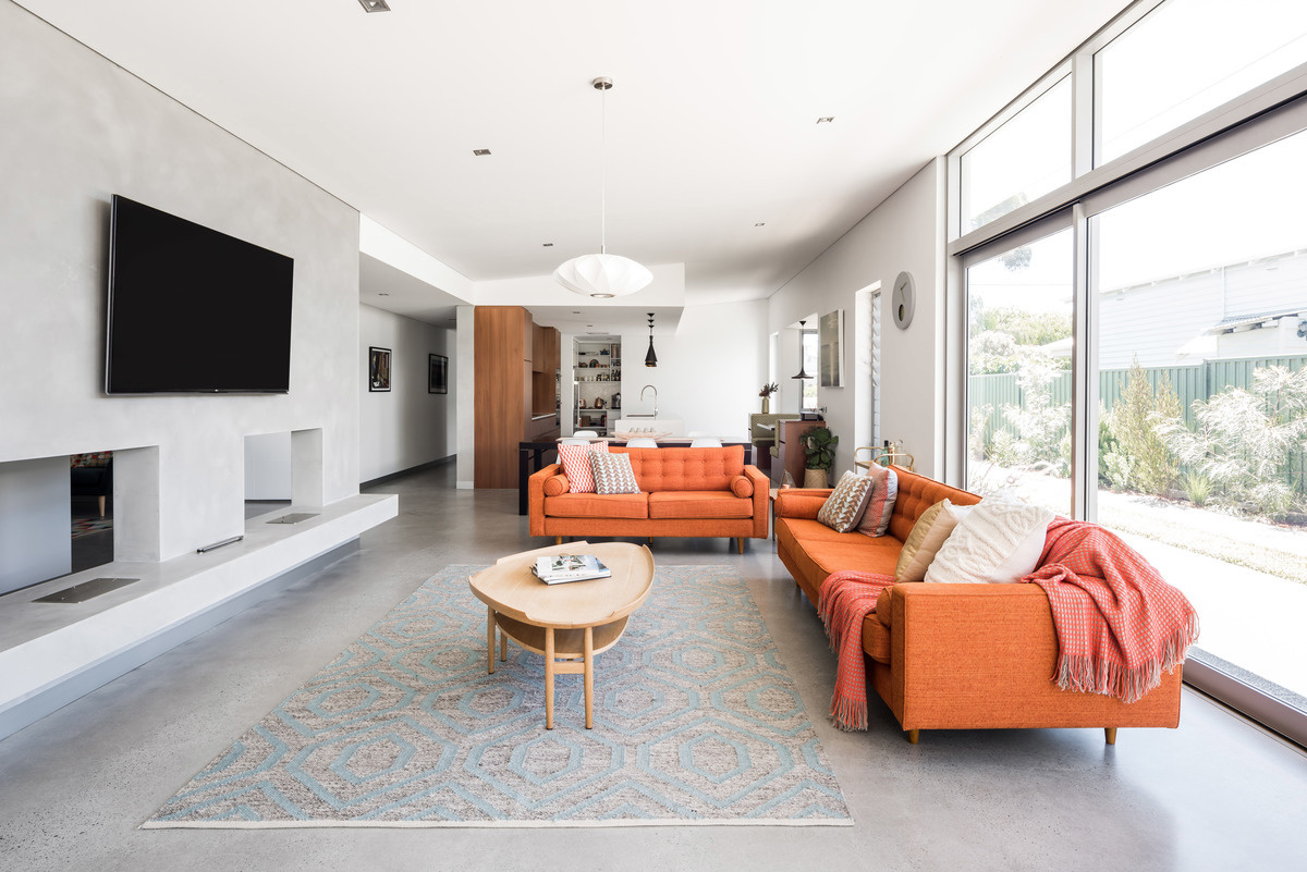 An airy living space with two fireplaces that connects effortlessly to the outdoors, perfect for relaxed Australian living.
