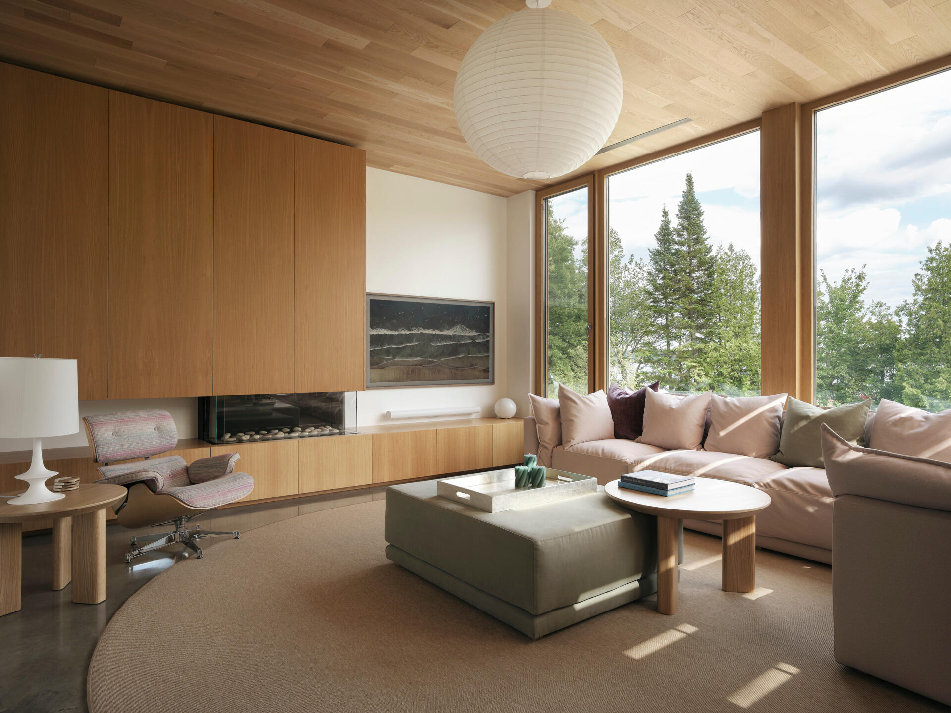 This living room is filled with natural light that bounces off white finishes and pale wood surfaces. 