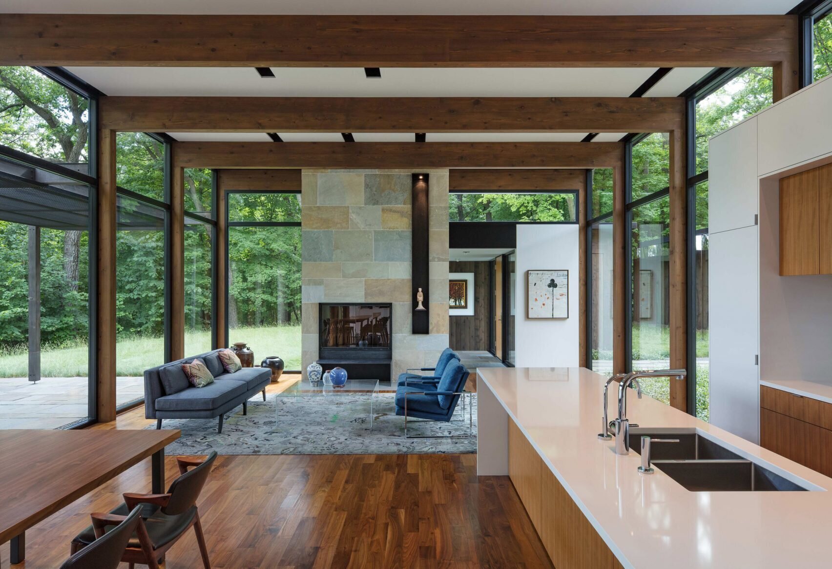 A bright open living space centered around a striking bluestone fireplace.