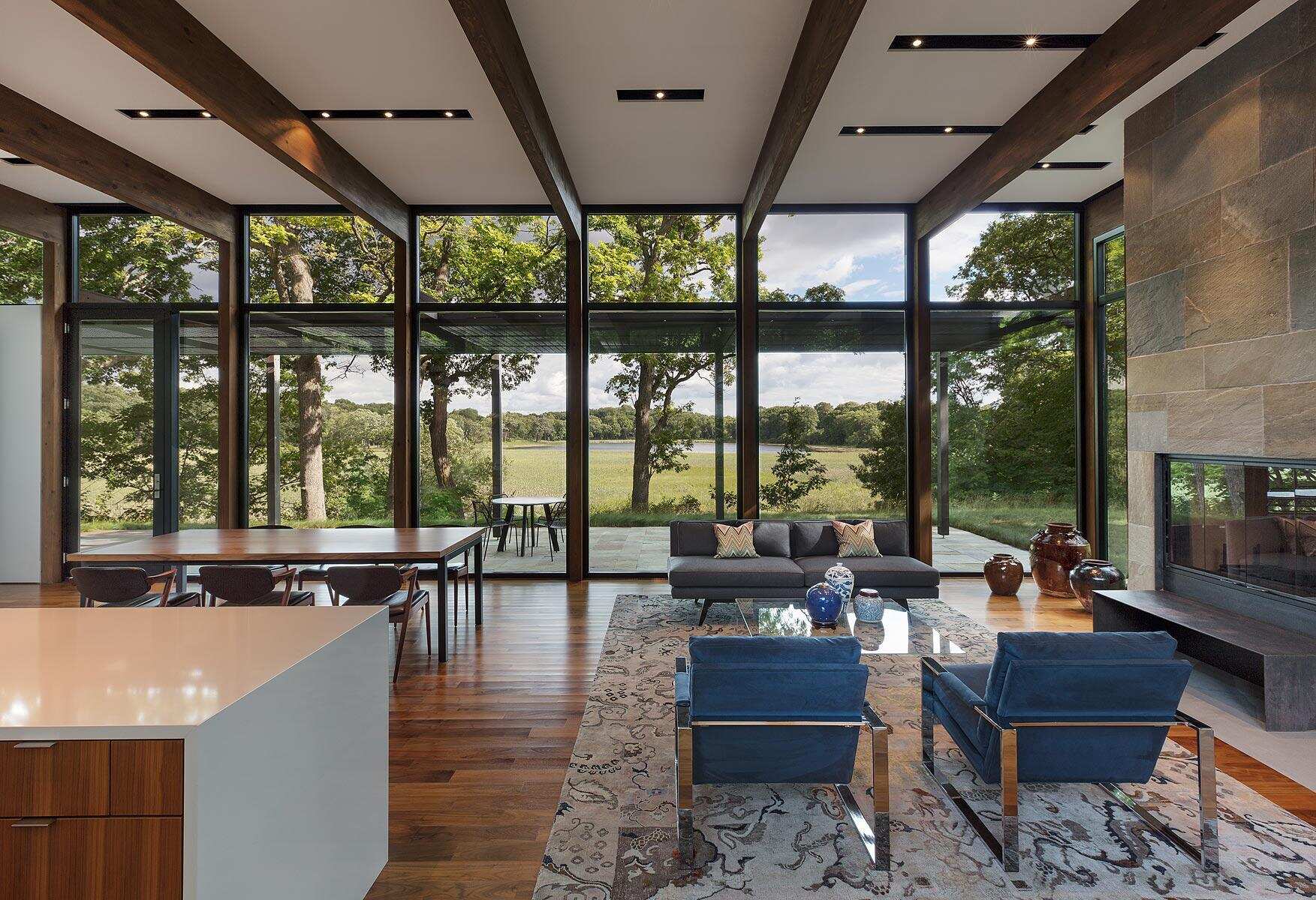 A bright open living space centered around a striking bluestone fireplace.