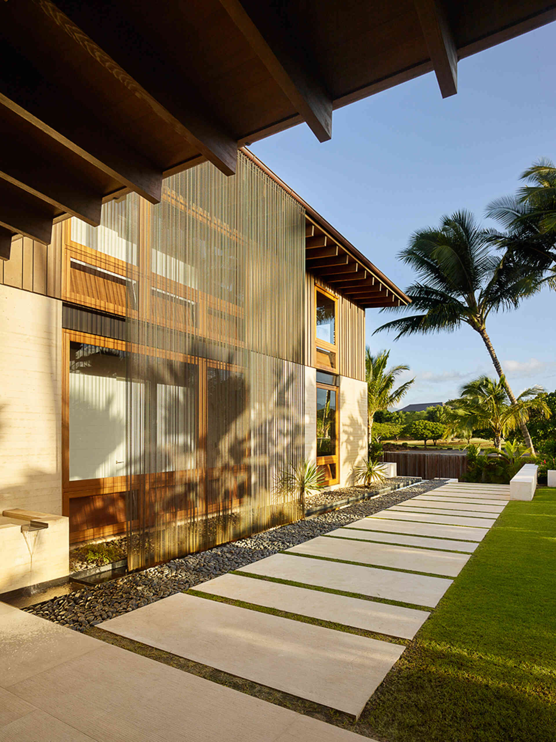 A clever copper rain curtain offers privacy, water management, and a touch of magic in this beachfront Kauai home.