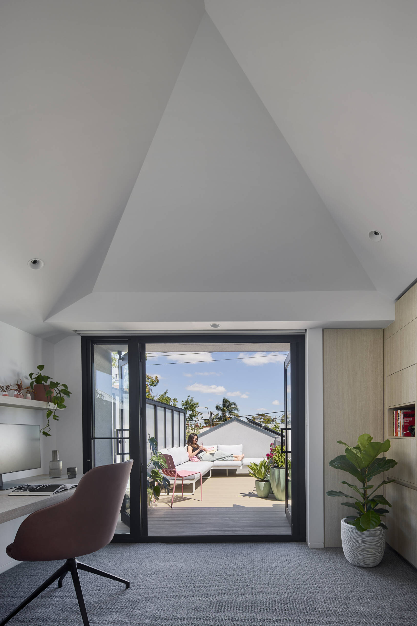 At the top of the stairs, there's a study zone and built in storage to support day to day family life, while a rooftop deck provides outdoor space.