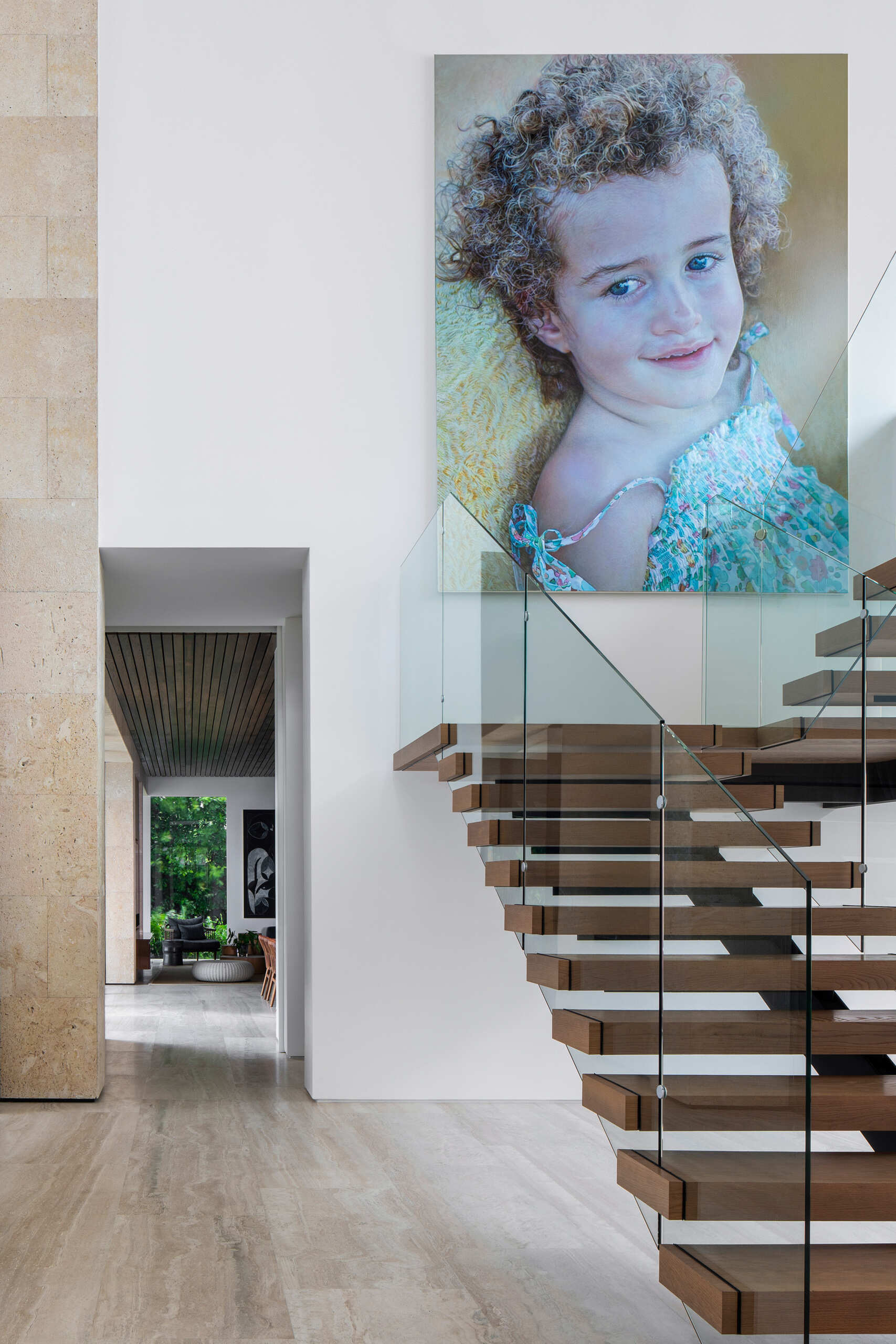 Interiors filled with timber, stone, and local artwork create a warm contrast to the clean architecture.