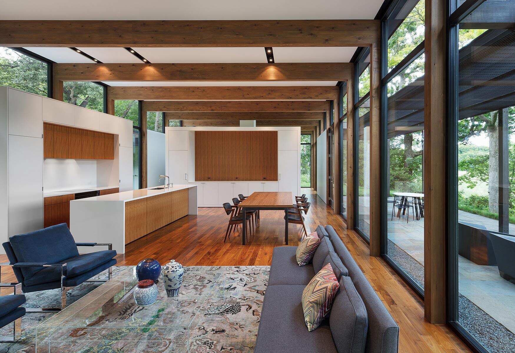 A soft mix of walnut, white walls and clean lined cabinetry in the kitchen.
