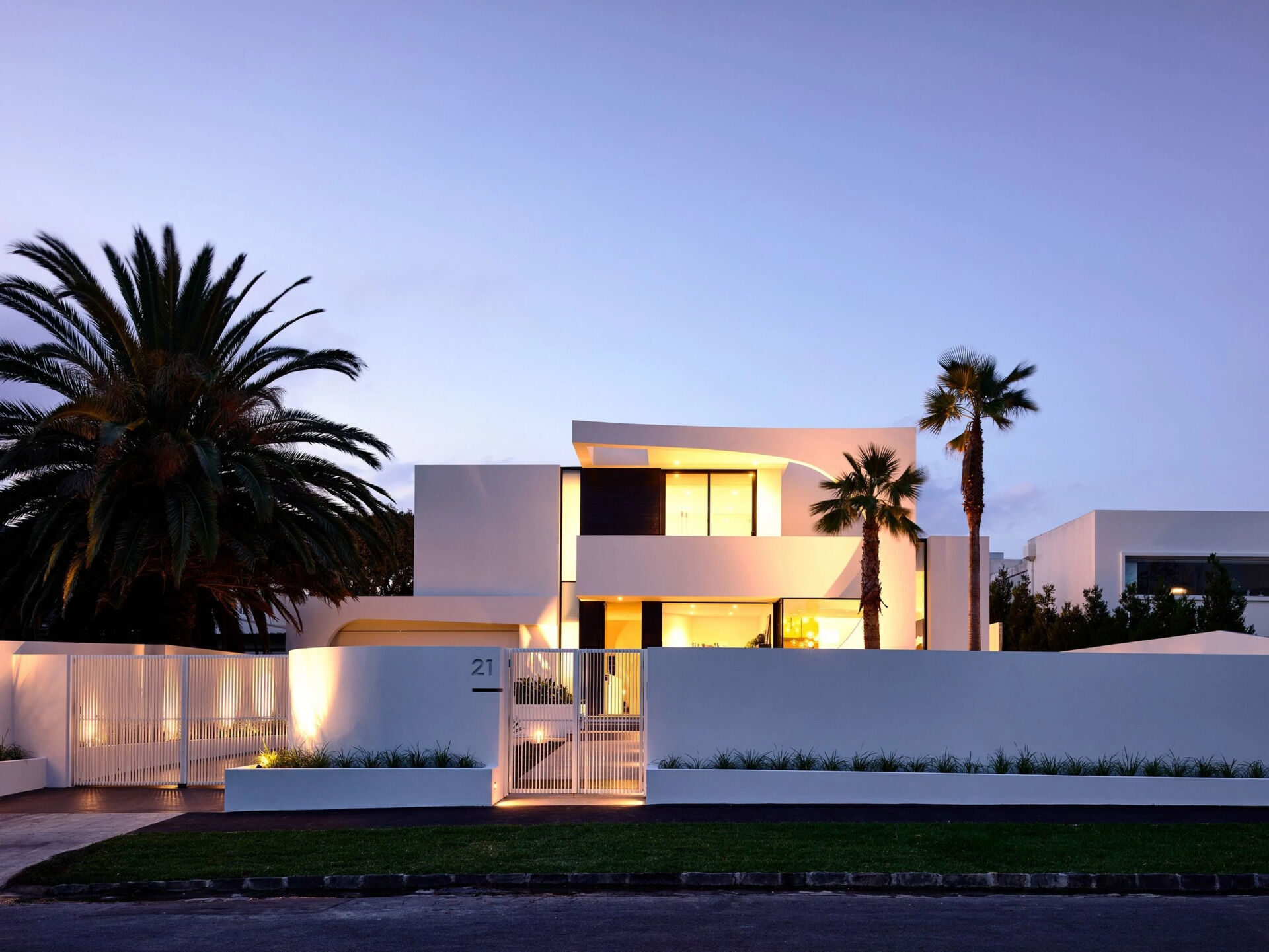 A bold concrete facade with sweeping curves and black Japanese oak detailing that instantly sets the tone for this modern Brighton family home.