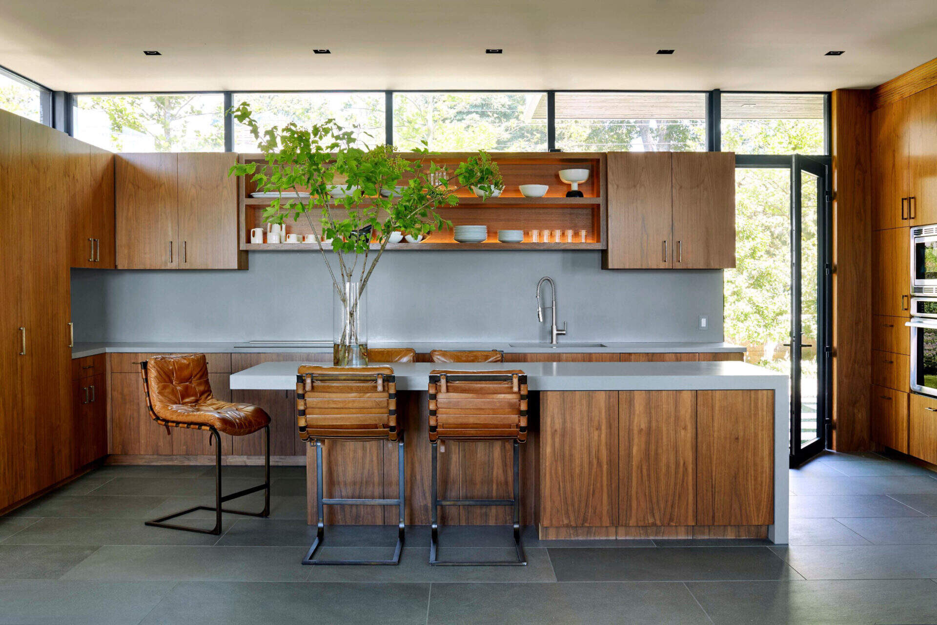Soft blue counters and warm wood cabinetry create a kitchen that feels fresh, inviting and ready for everyday cooking or weekend hosting.