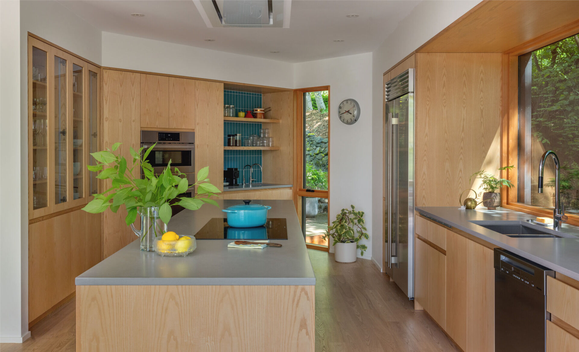 The kitchen saw the greatest transformation. SHED removed a small den near the entry and added a bump out, creating a larger, fully functioning center for family life. Caesarstone Pebble counters and Fireclay Neptune tile define the workspace, while its open links to the living and dining areas finally give the home the circulation it lacked.