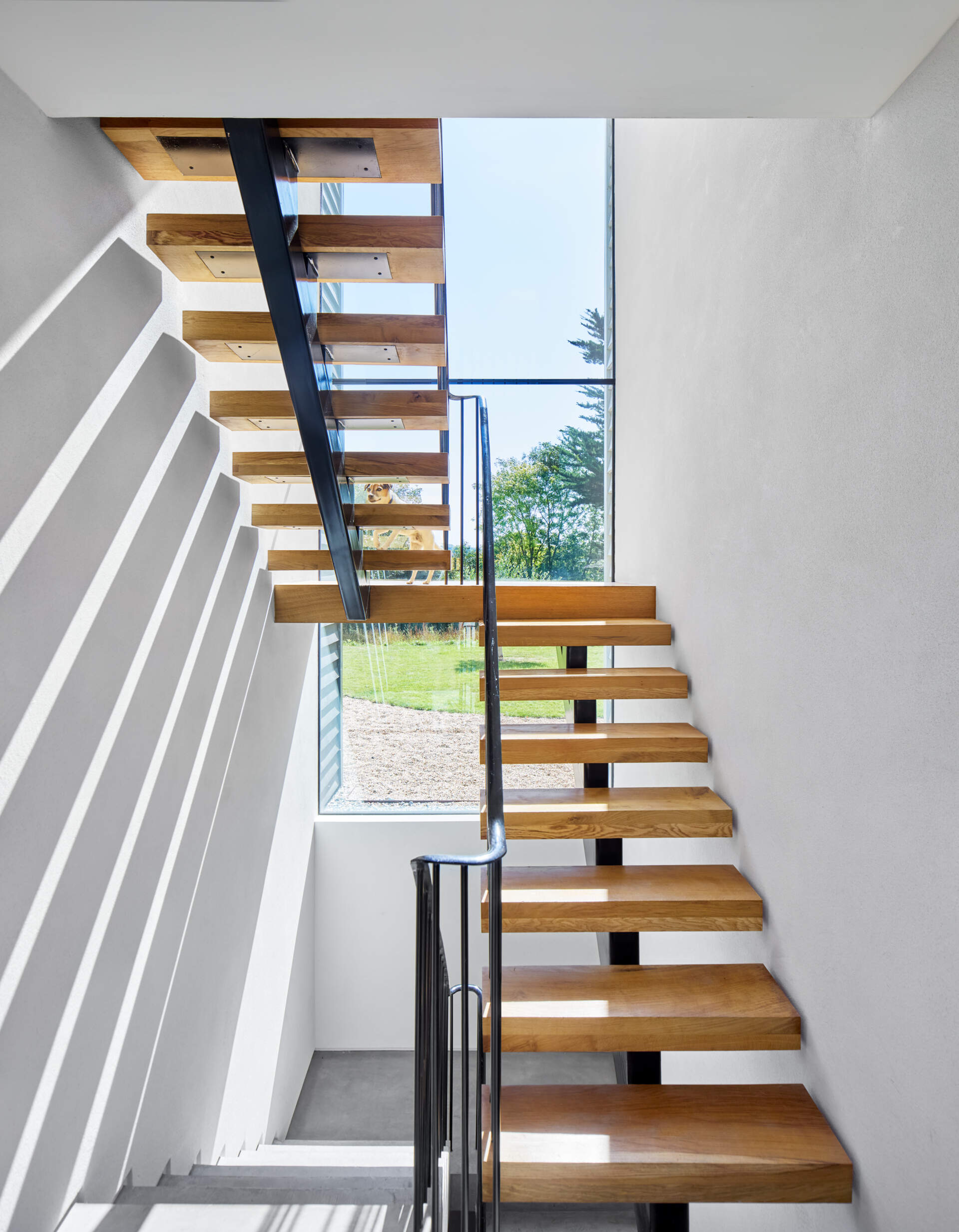 The feature steel and wood staircase was one of the key elements shaped with detailed input from Emrys Architects. It stands as a focal point within the home’s clean, modern interior.