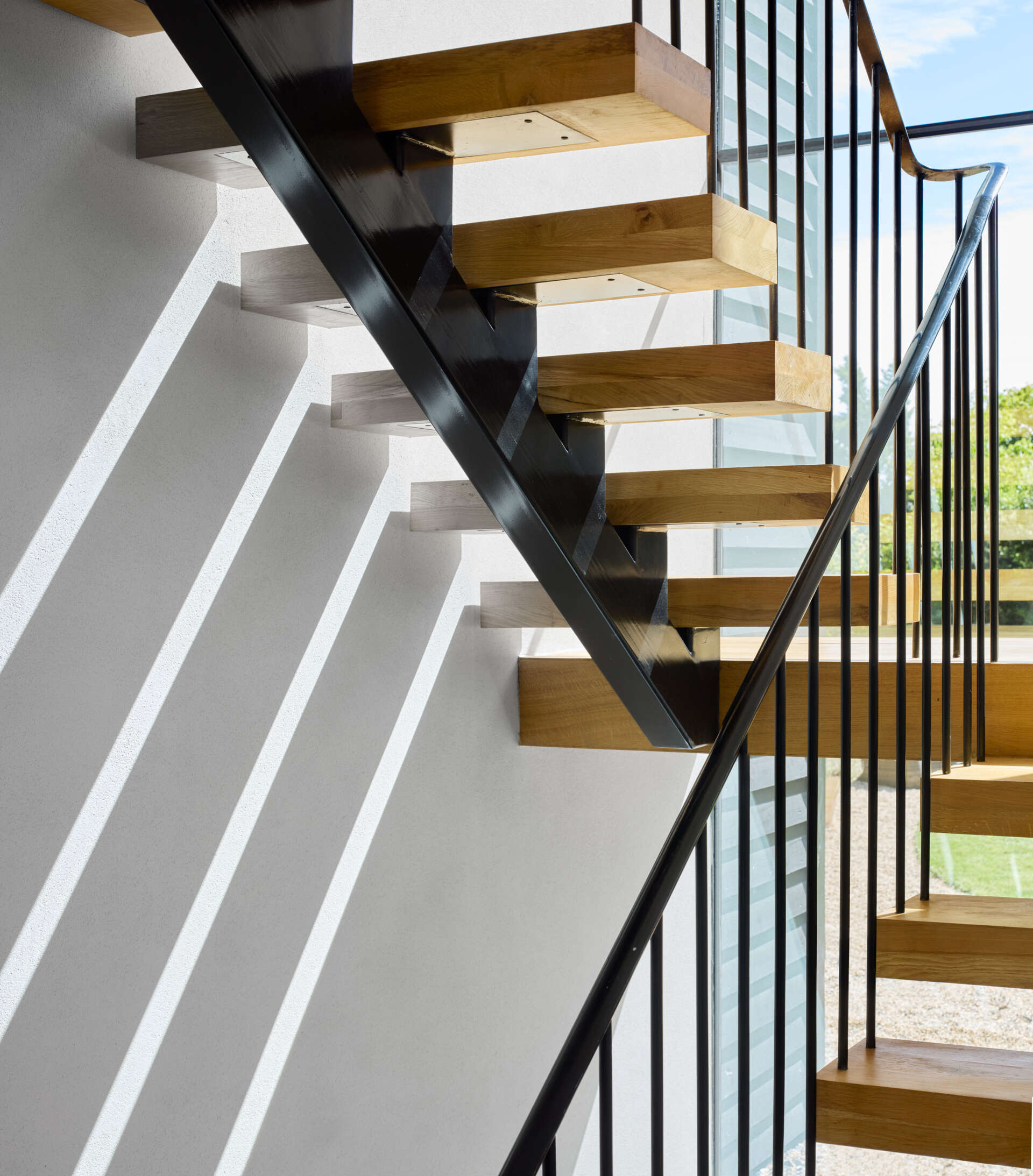 The feature steel and wood staircase was one of the key elements shaped with detailed input from Emrys Architects. It stands as a focal point within the home’s clean, modern interior.
