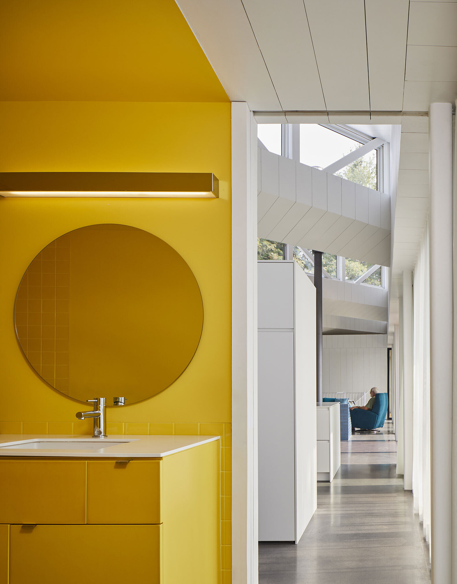 Unexpected color brings joy to this Canadian home, from pink coat hooks in the hallway to a cheerful yellow bathroom that lights up the all-white interior.