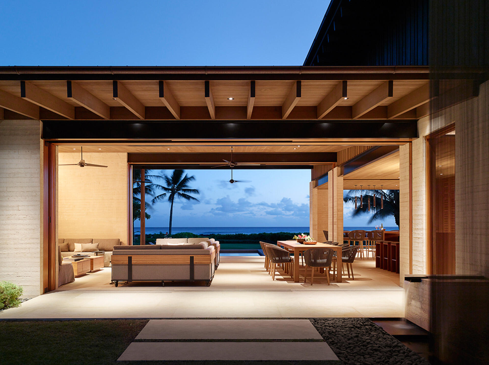 A custom 30-foot U-shaped sofa turns the living room into the heart of this Hawaiian retreat, perfect for lounging or sunset watching.