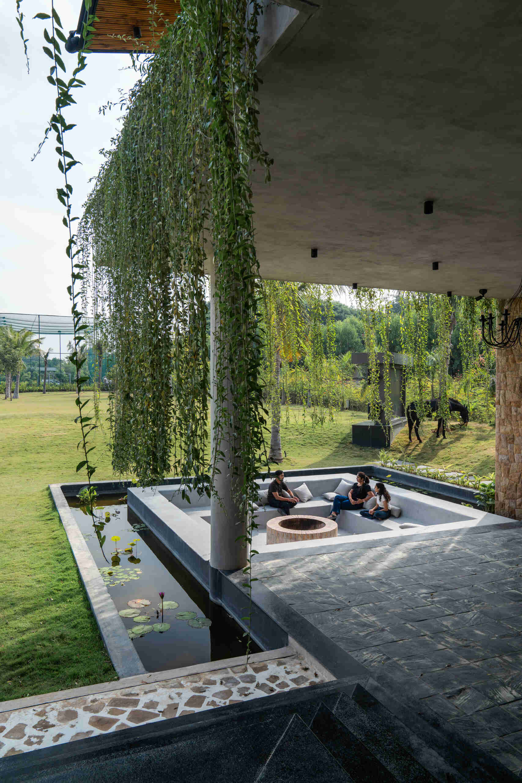 A sunken lounge set into the landscape creates a cozy gathering spot beside the garden.