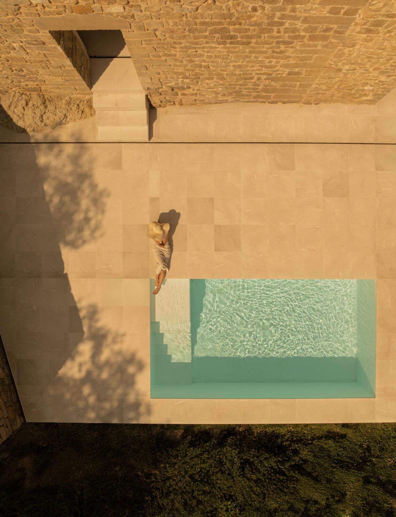 Carved from an old cistern, the pool at Mas Cadalt reflects the surrounding landscape like glass, a peaceful blend of history, sustainability, and quiet elegance.