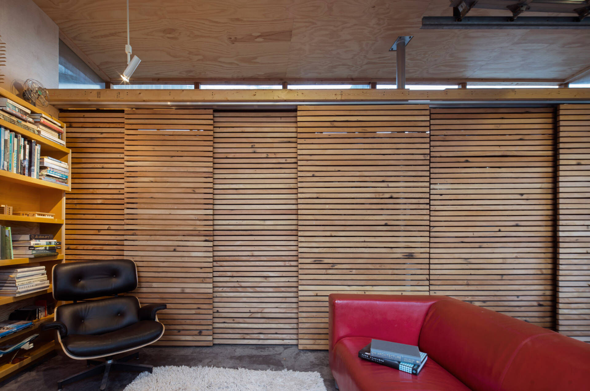 Clever sliding barn doors hide storage and a small bathroom, adding function without clutter.