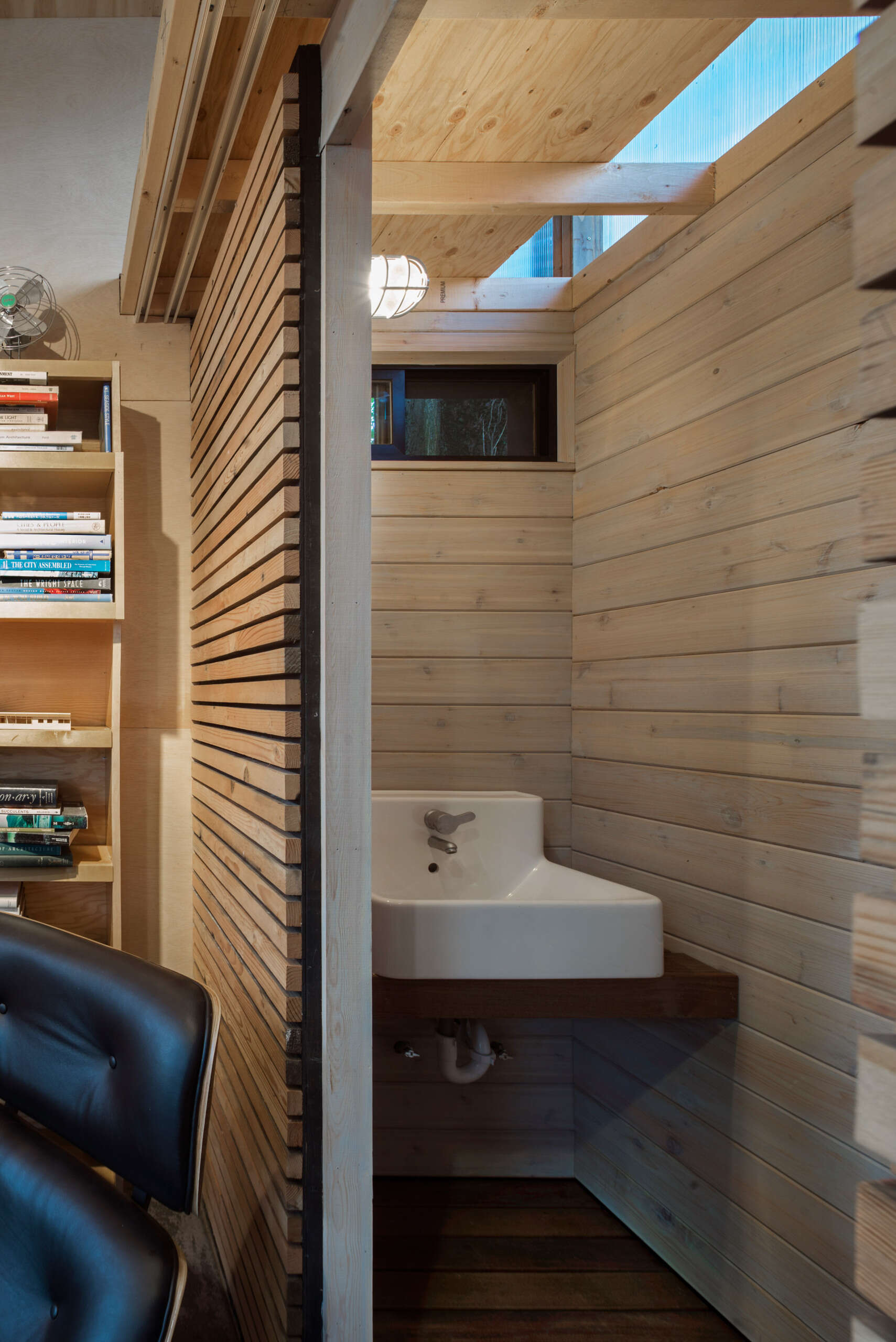 Clever sliding barn doors hide storage and a small bathroom, adding function without clutter.