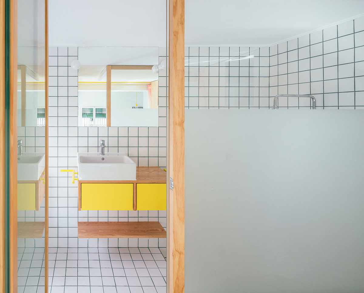 A sunken bathtub and mirrored finishes turn the small bathroom into a bright, spa inspired retreat.