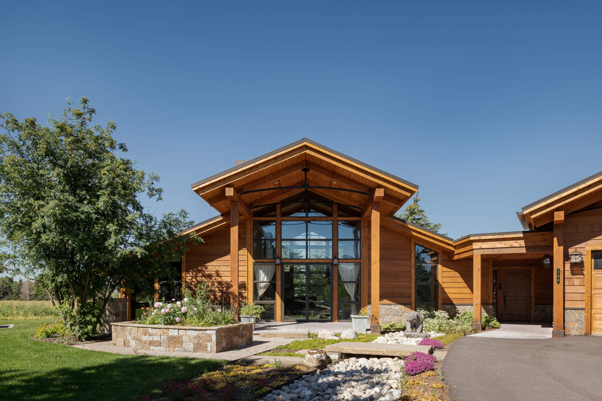 A carefully designed pathway across a dry creek bed connects the two family homes, blending the properties into the natural landscape and creating a serene outdoor experience.