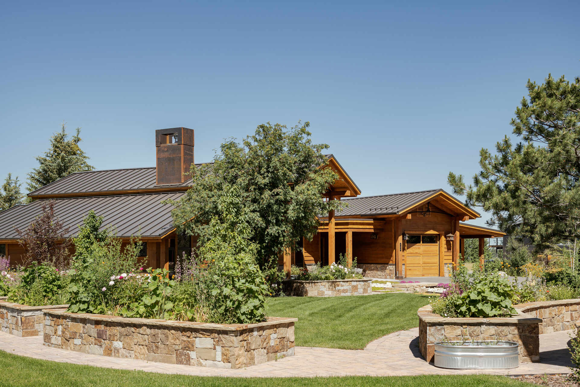 A carefully designed pathway across a dry creek bed connects the two family homes, blending the properties into the natural landscape and creating a serene outdoor experience.