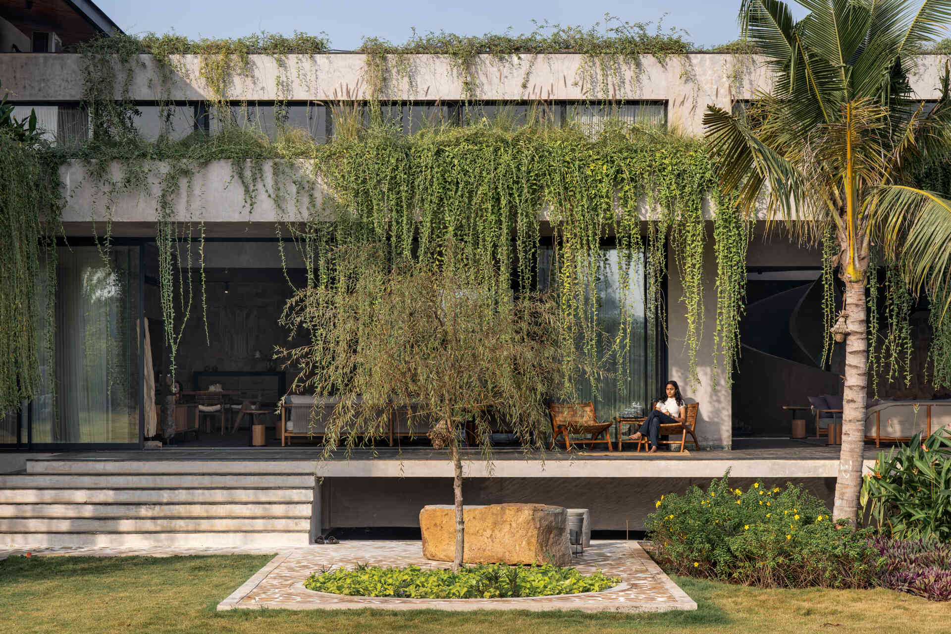 Floating walkways and hanging plants soften the architecture of this modern house and connect it to nature.