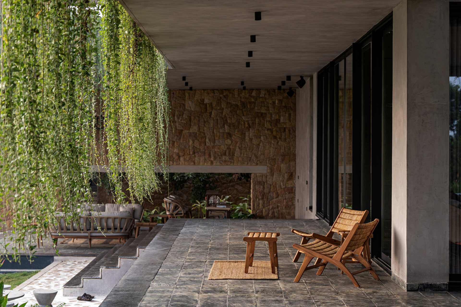 Floating walkways and hanging plants soften the architecture of this modern house and connect it to nature.
