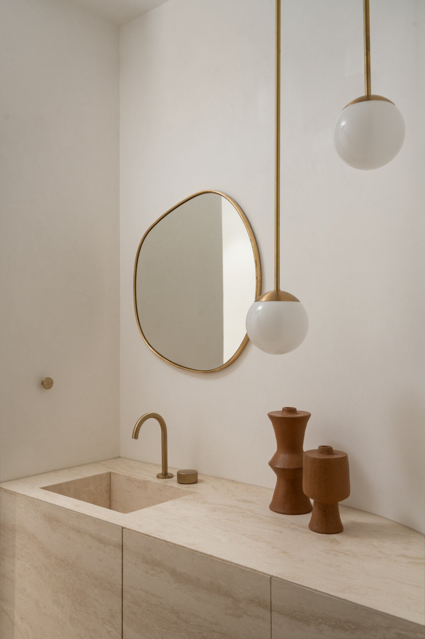 Clean lines and monolithic forms in the guest powder room.