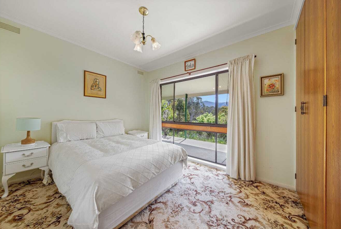 BEFORE THE RENOVATION - An untouched 1960s home that once felt dark and closed off from its incredible mountain surroundings.