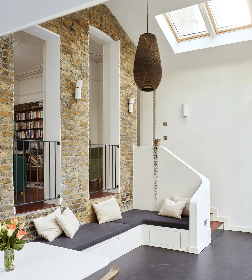 A striking brick wall anchors the new extension and creates a natural divide between the Victorian interior and the modern addition.