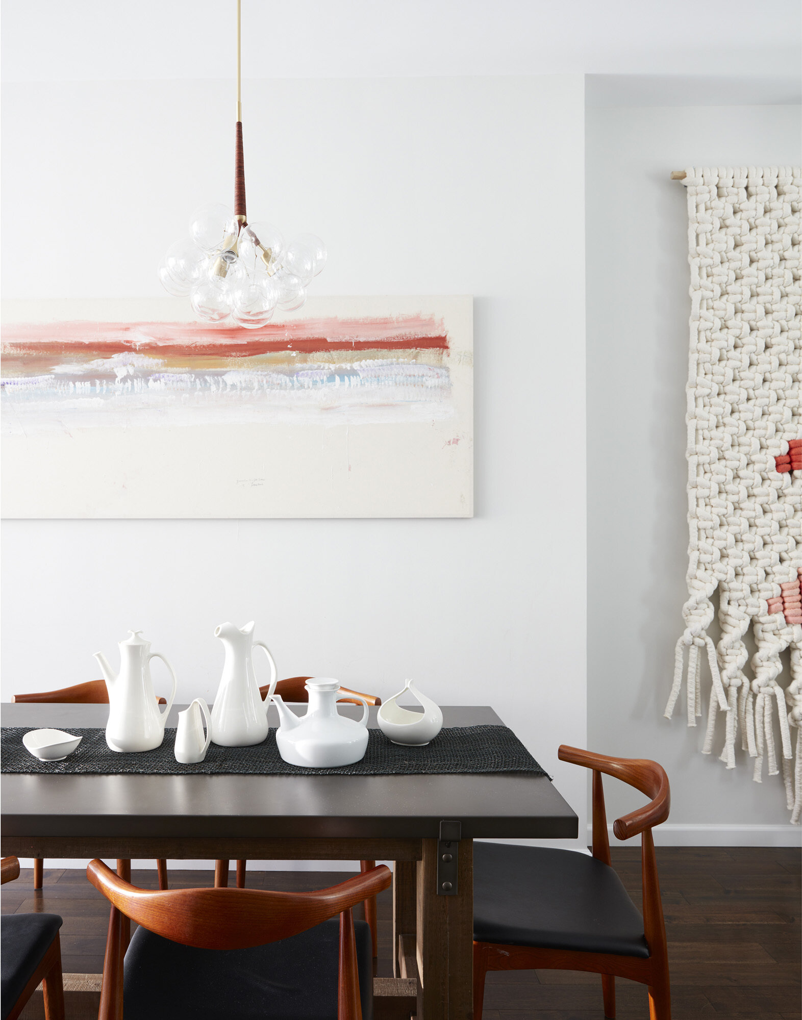 Mid century inspired furnishings create a simple and contemporary dining space for daily meals.