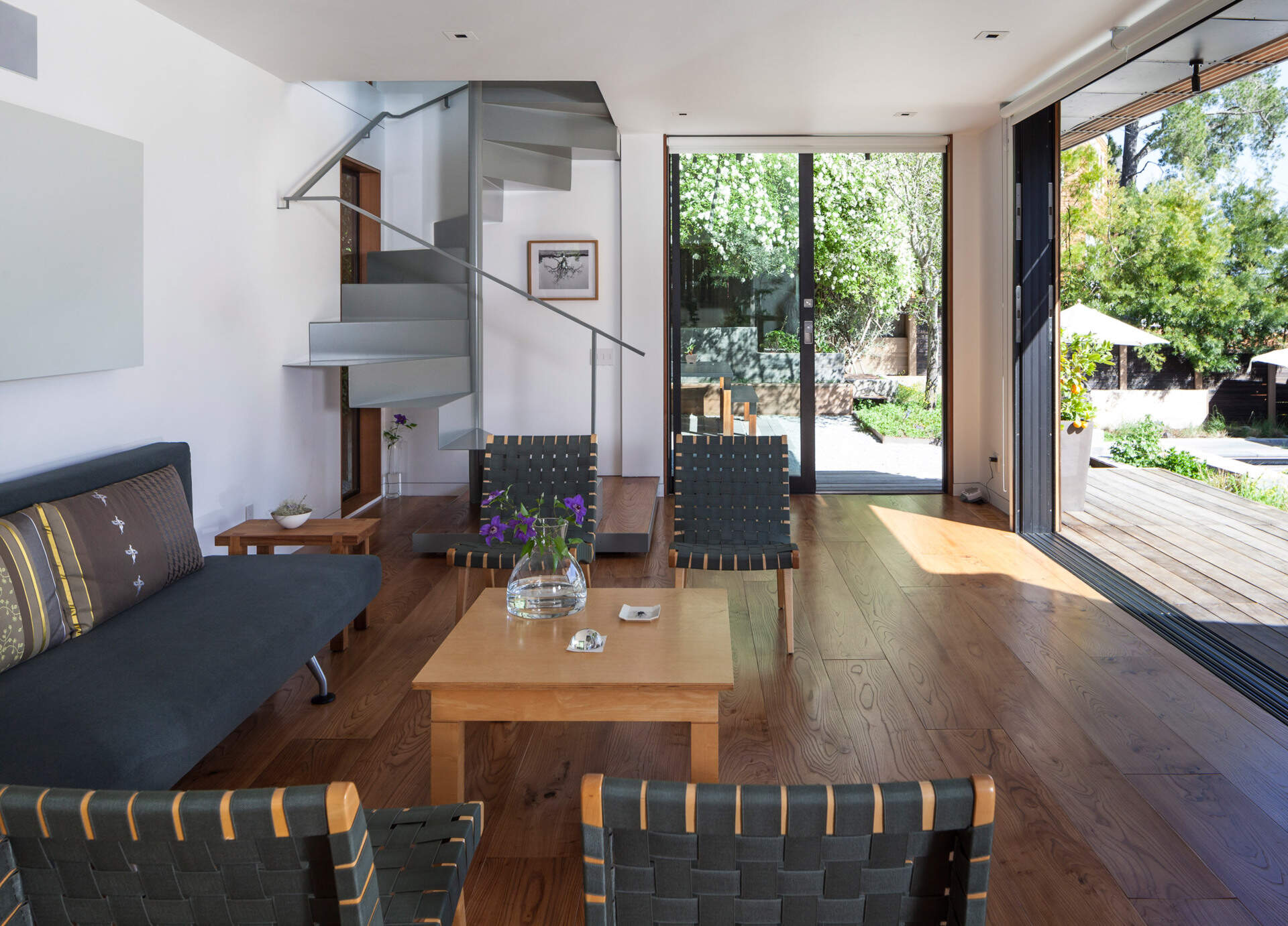 Sliding glass doors connect the living room to the backyard, merging indoor and outdoor living.