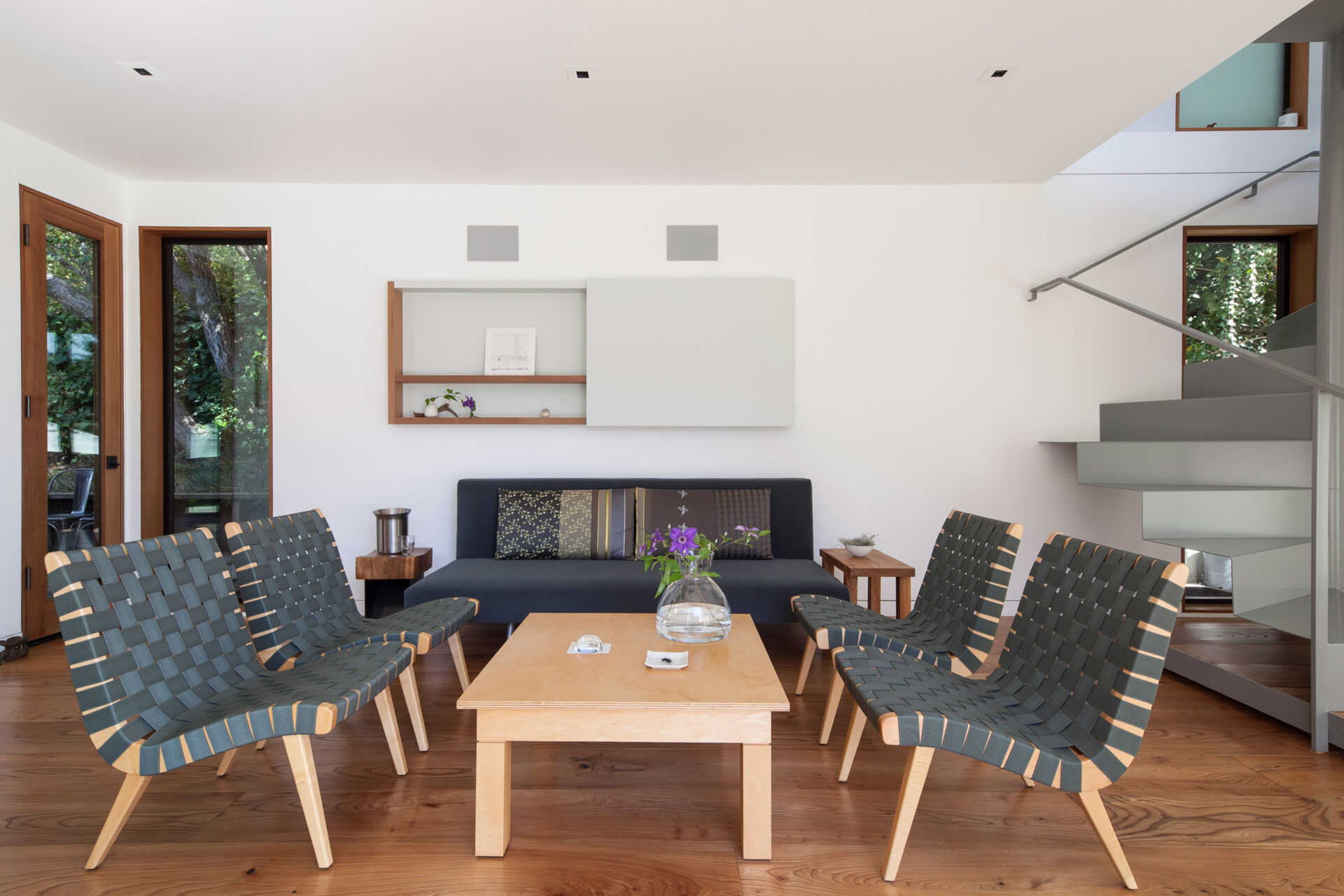 Sliding glass doors connect the living room to the backyard, merging indoor and outdoor living.