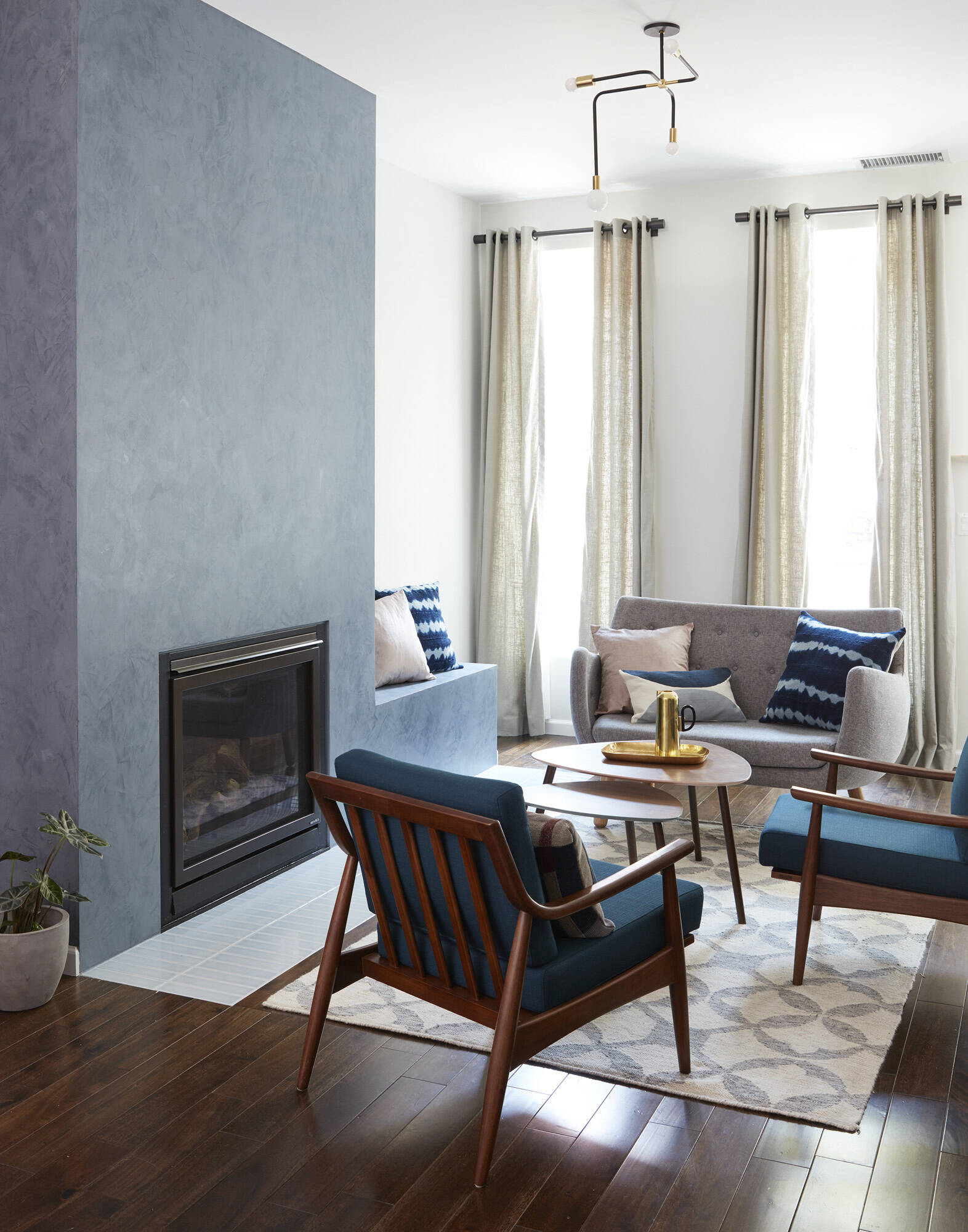 A cozy living room featuring a fireplace surround with a built in bench that blends comfort with thoughtful design.