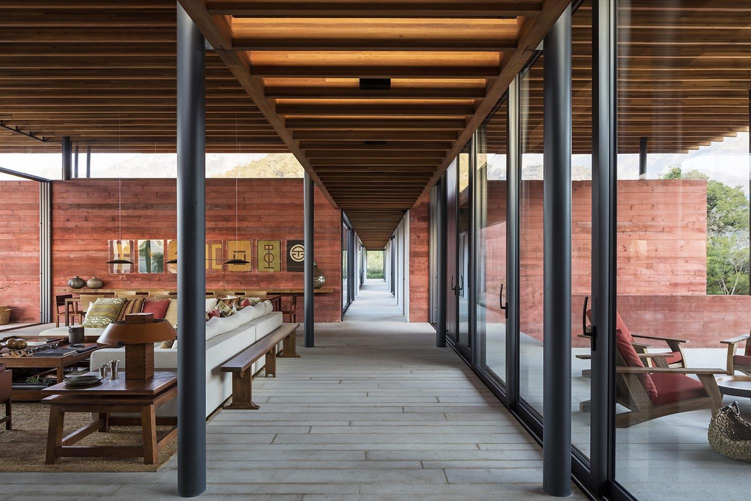 The long central hallway at Casa Terra links each space while maintaining uninterrupted views of the surrounding landscape.