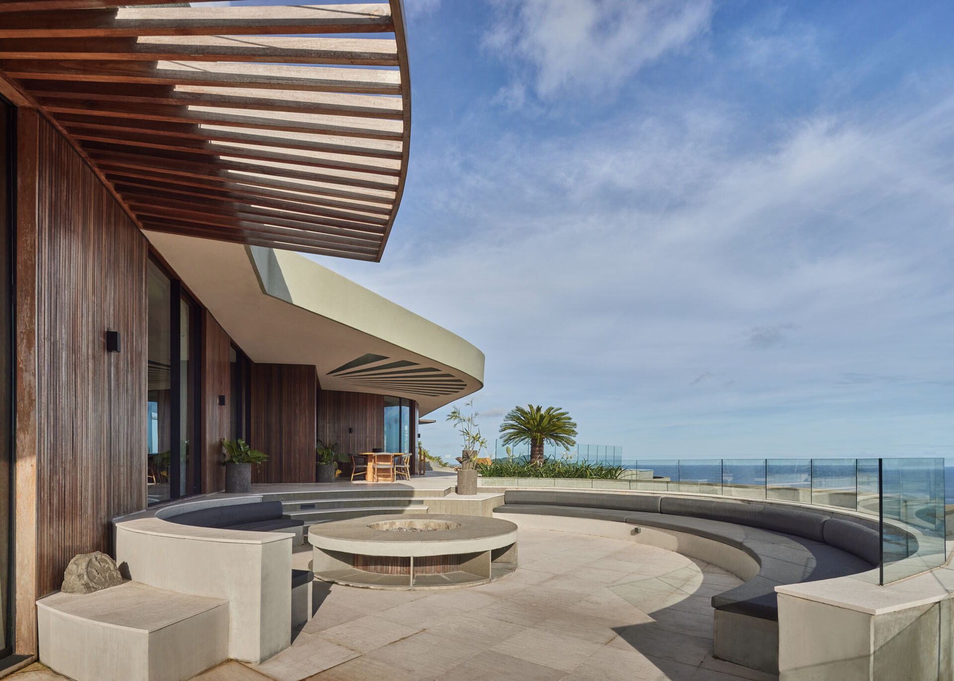 A circular fire pit with integrated seating becomes a natural gathering point shaped entirely by curved form.