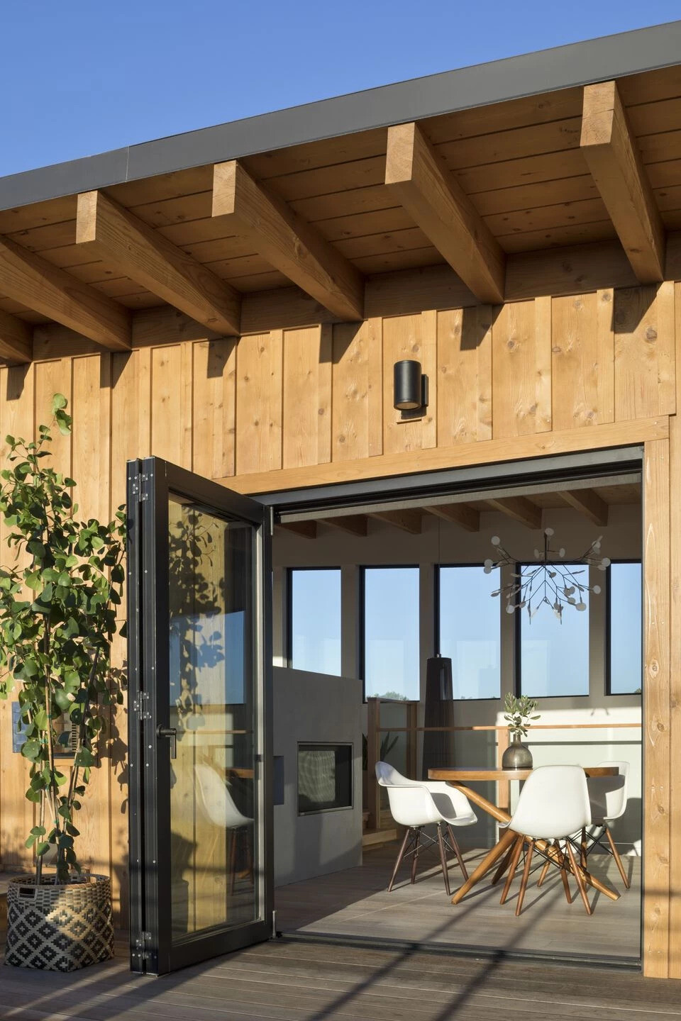 Bi folding doors open the dining area onto a deck, extending daily living into the outdoors.