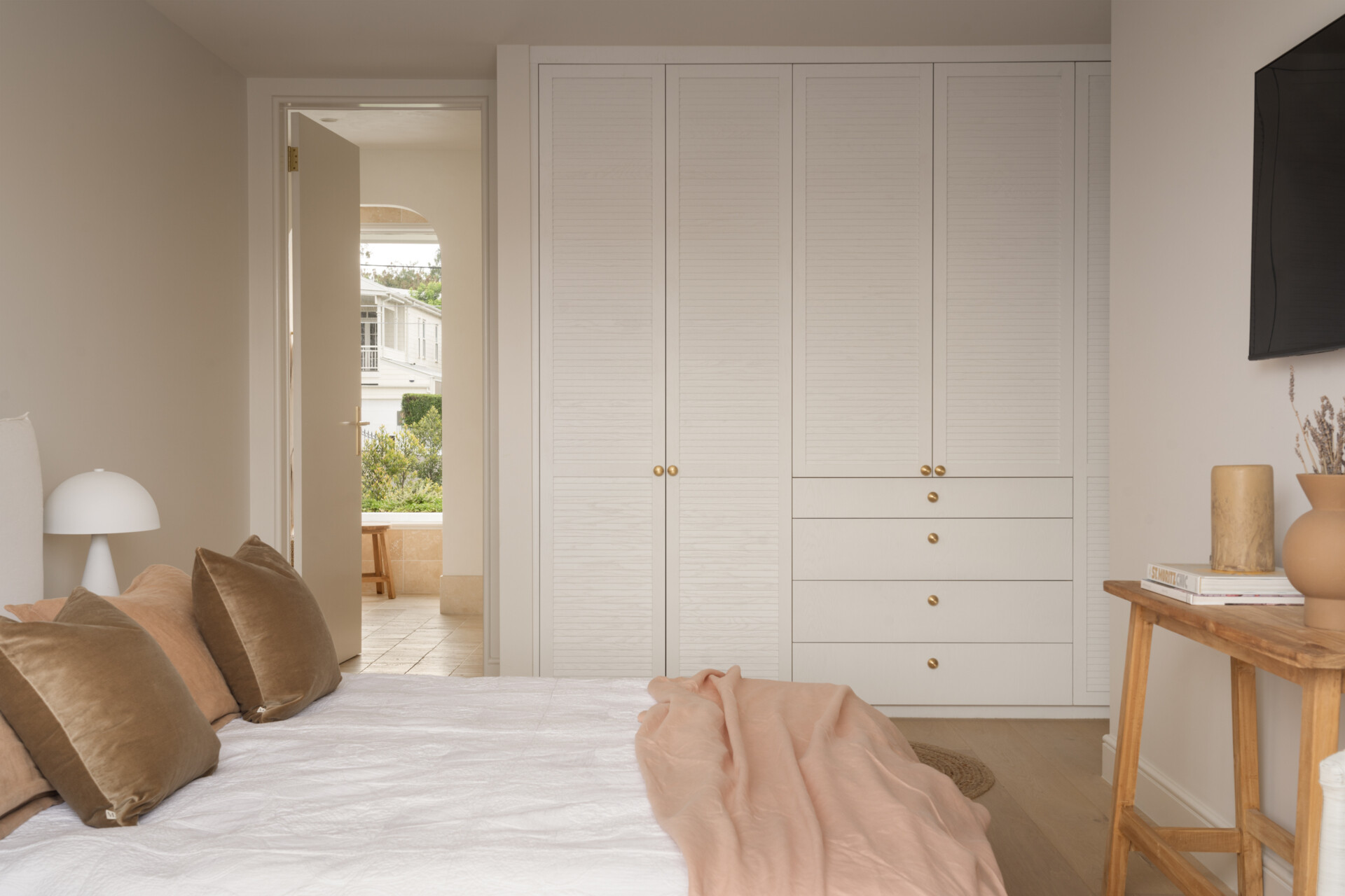 A modern guest bedroom with built-in closets.