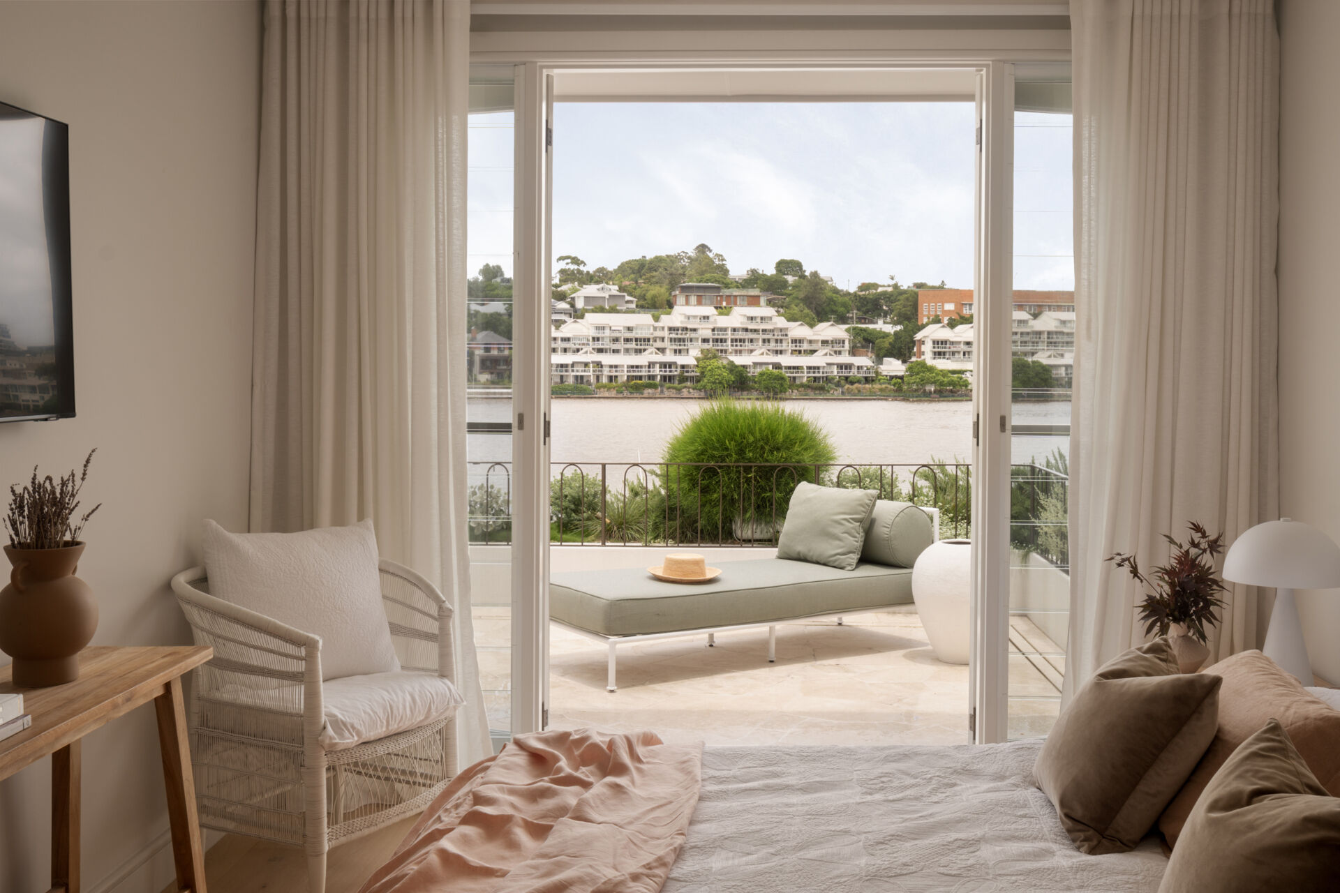 A modern guest bedroom opens to a patio.