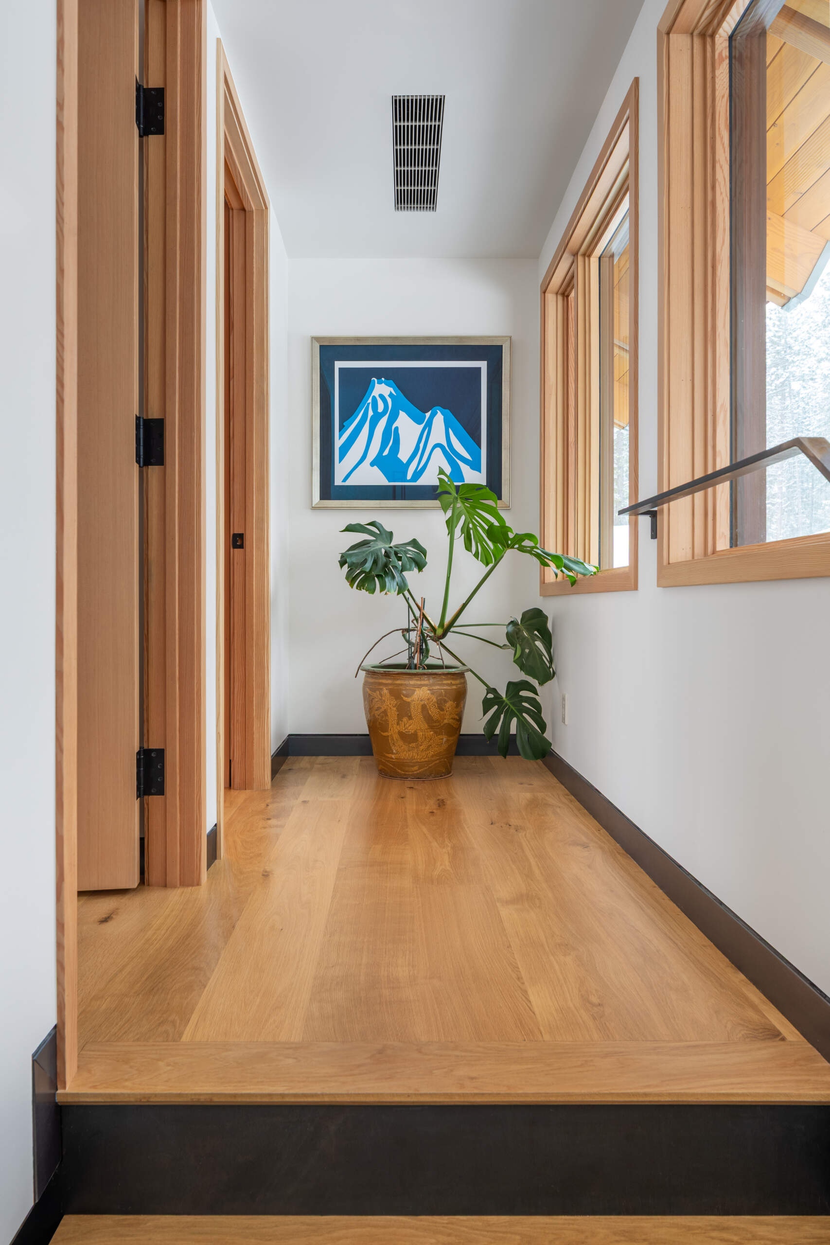 A simple hallway at the top of the stairs.