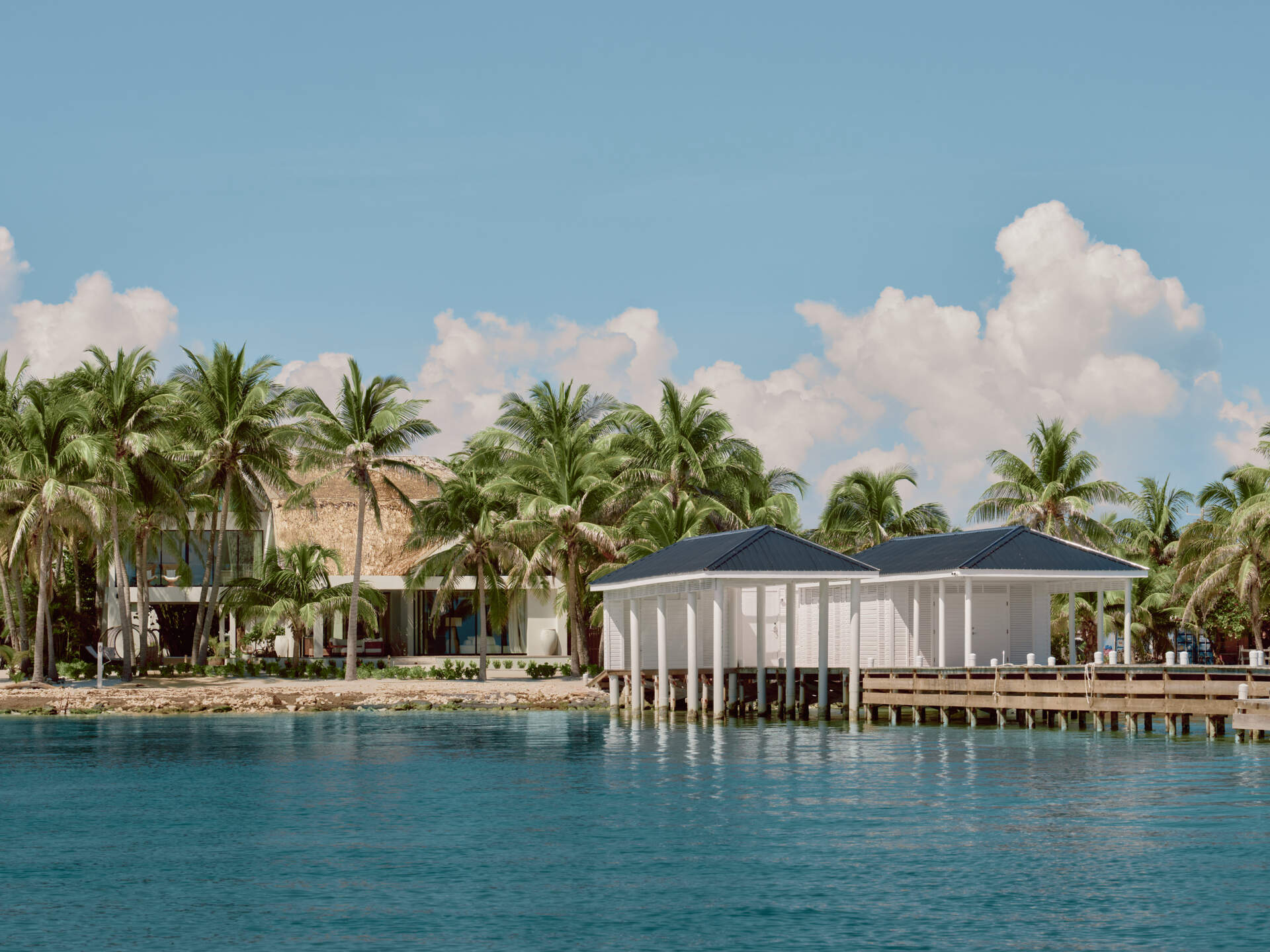 The boathouse was the first structure completed, reflecting the homeowners’ connection to the sea. Built directly over the water, it provides covered boat storage and space for fishing and diving gear. When the boat is docked, the platform becomes a place for watching sunrises, fishing, and cleaning fresh catches just steps from the kitchen.
