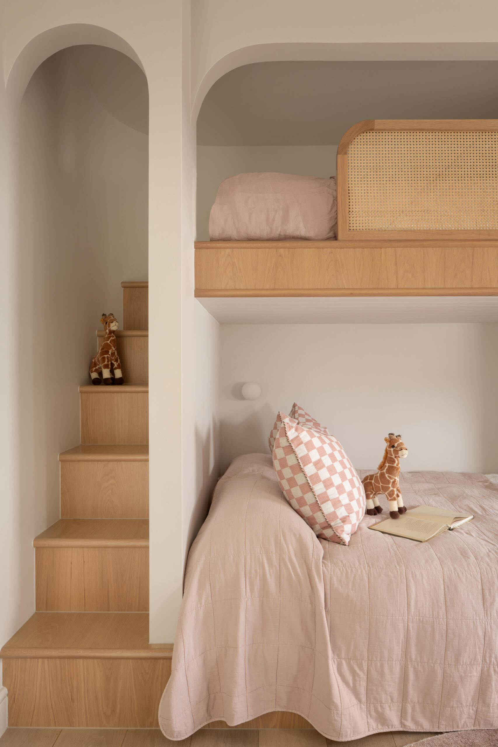 A whimsical kids’ room with custom curved-alcove bunk beds that feel cosy and built-in.
