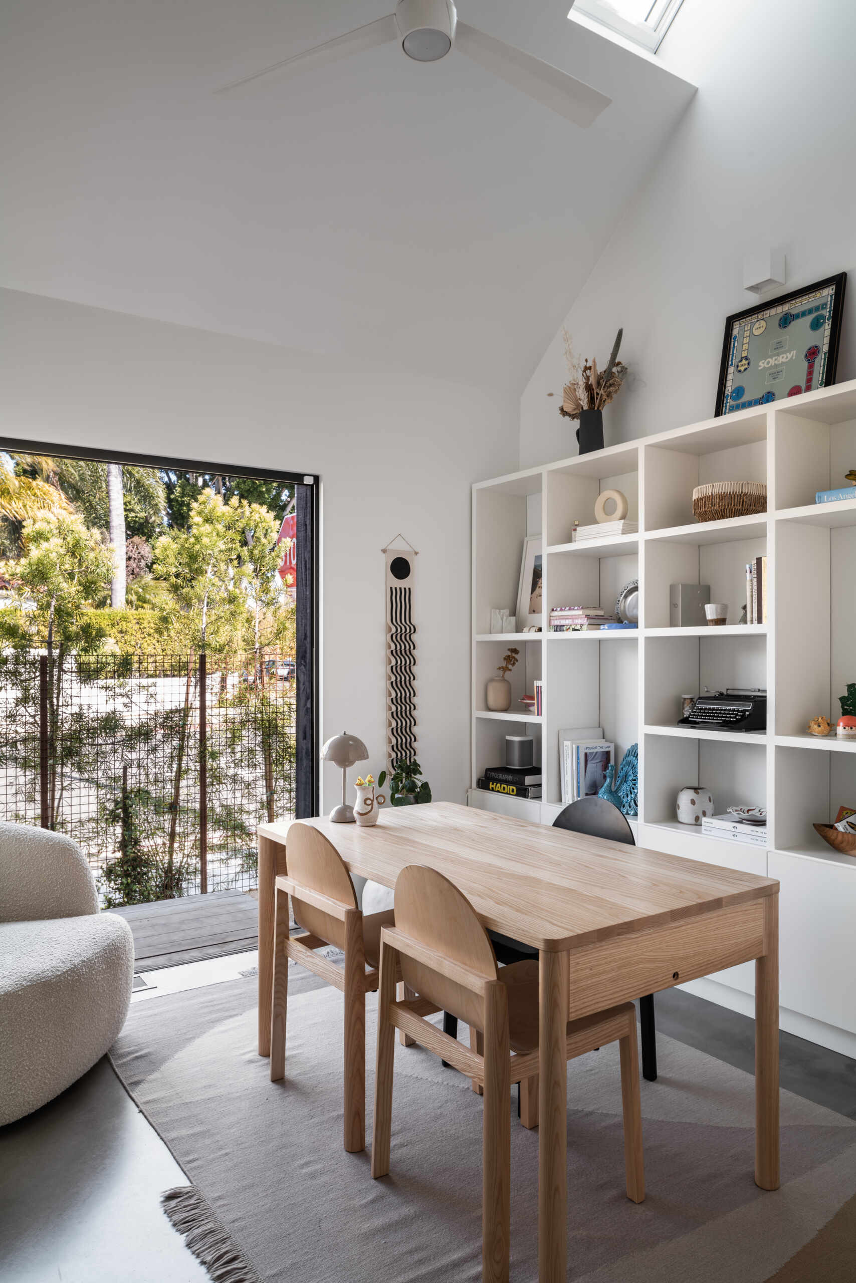 A dedicated office space within this ADU allows for separation between work and family life. Its placement ensures privacy while maintaining access to the backyard and shared outdoor areas.