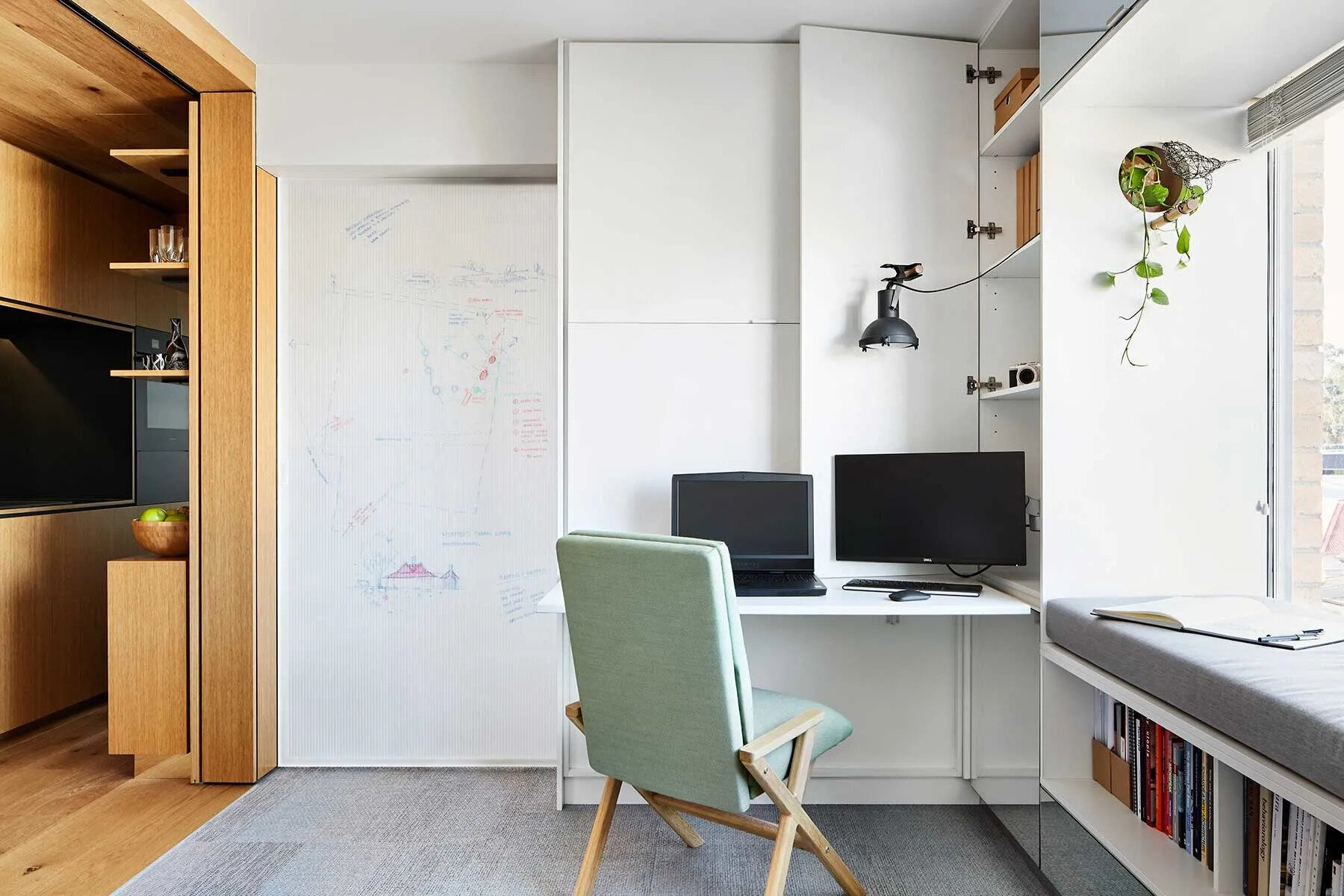 A translucent sliding door with a built-in whiteboard separates the bedroom while still allowing light to flow through the apartment.