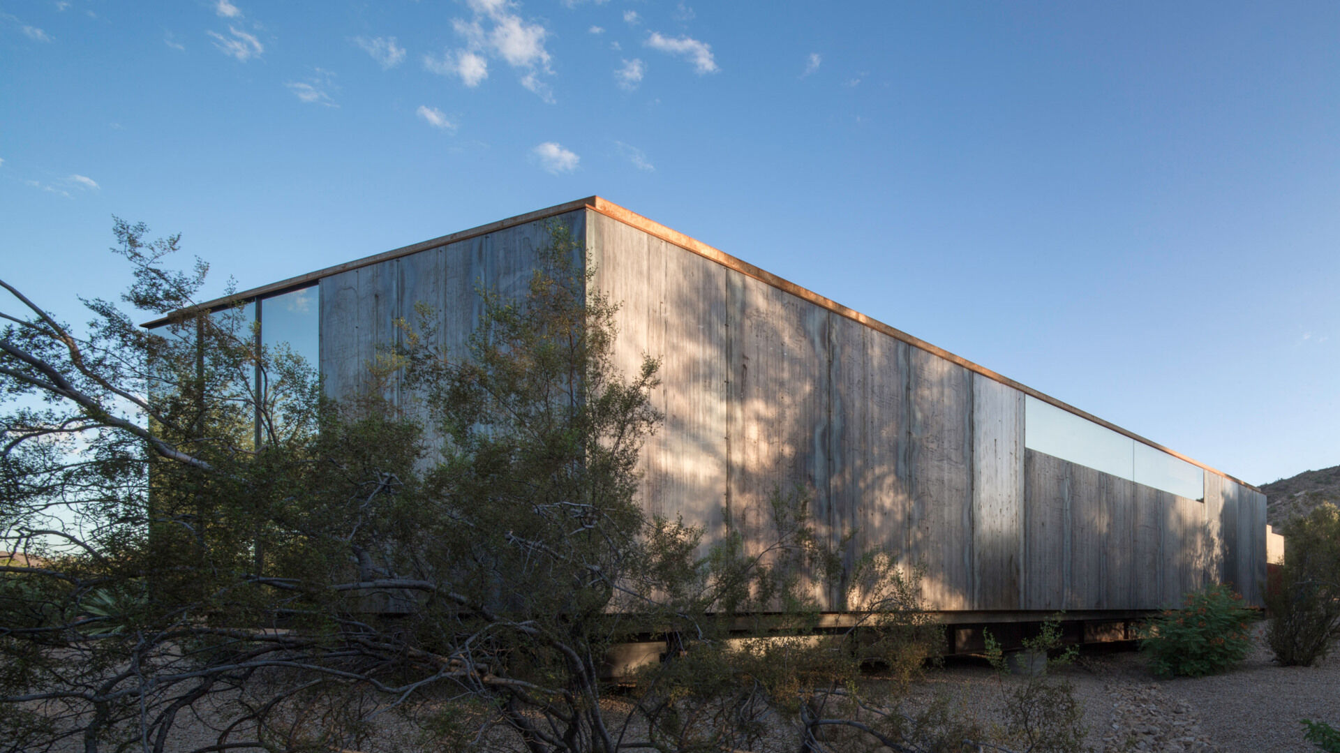 Weathering steel and glass give this Arizona art studio a bold yet restrained presence in the desert.